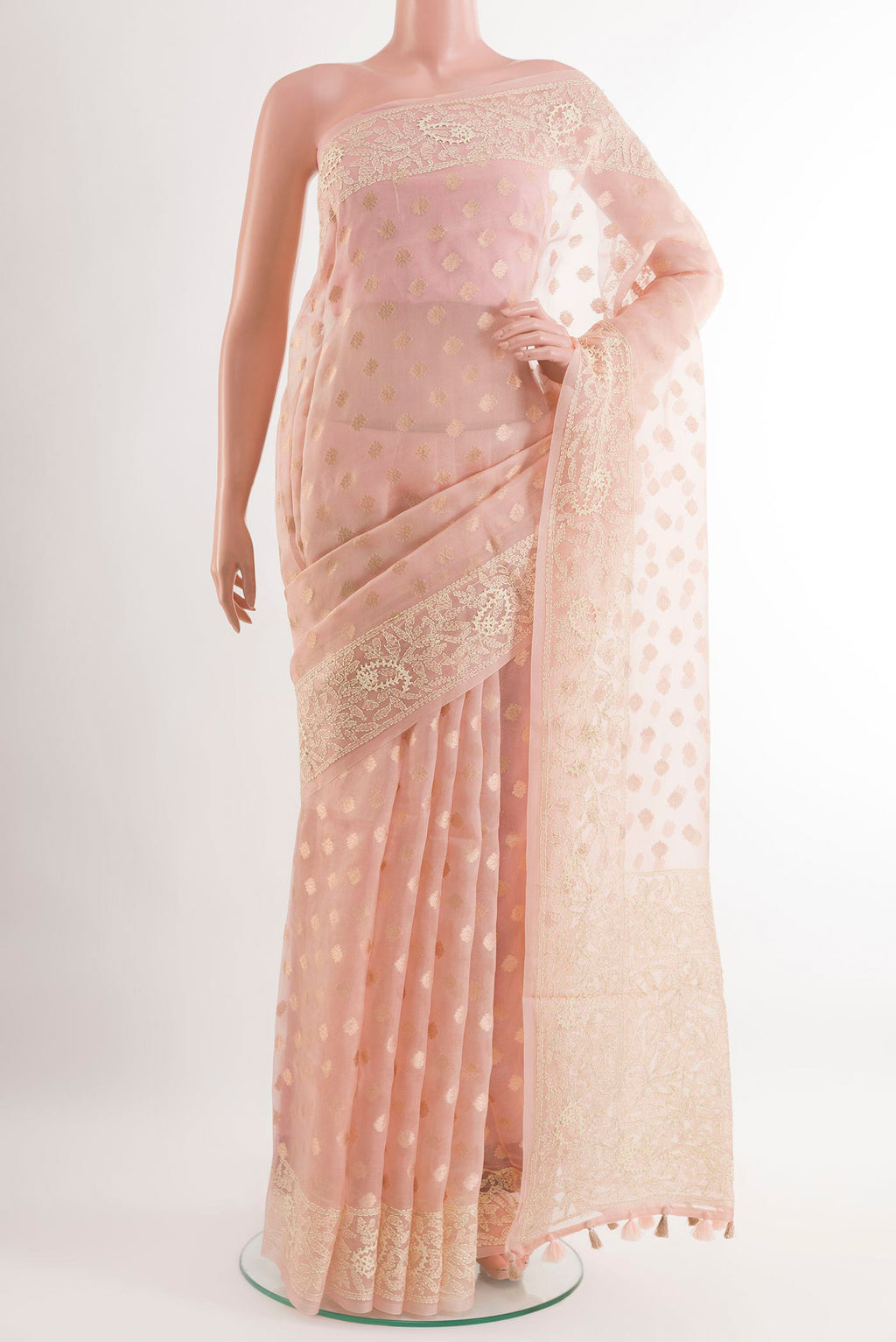 Peach Organza Silk Saree with Zari Butta on the body and Embroidery Border.  displayed on a mannequin