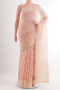 Peach Organza Silk Saree with Zari Butta on the body and Embroidery Border.  displayed on a mannequin