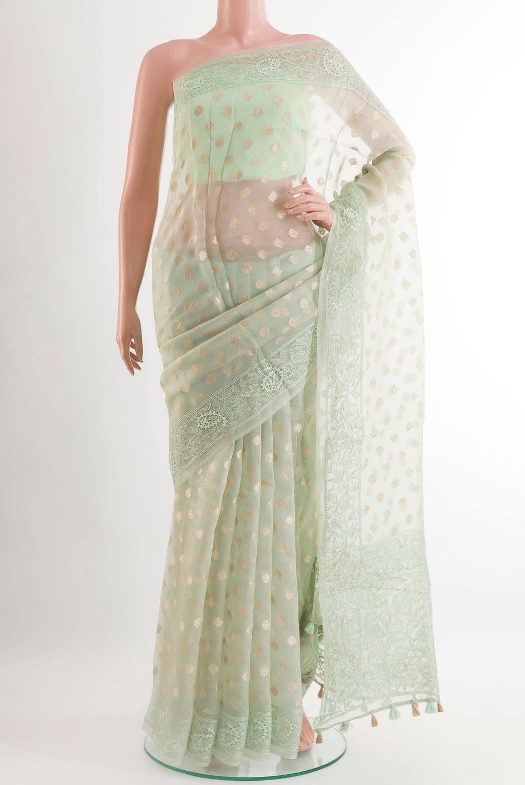 Green Organza Silk Saree with Zari Butta on the body and Embroidery Border.  displayed on a mannequin