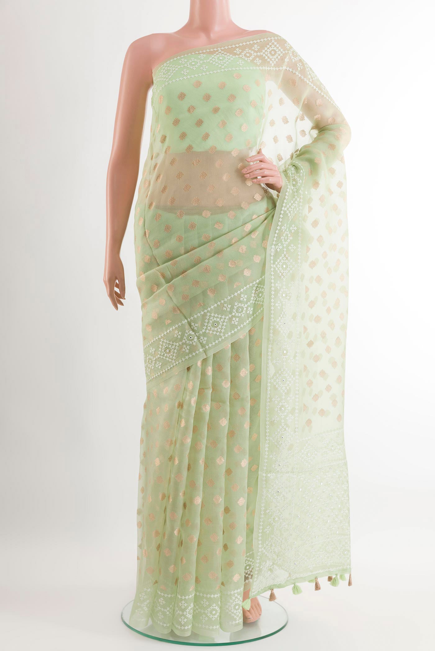 Green Organza Silk Saree with Zari Butta on the body and Embroidery Border.  displayed on a mannequin