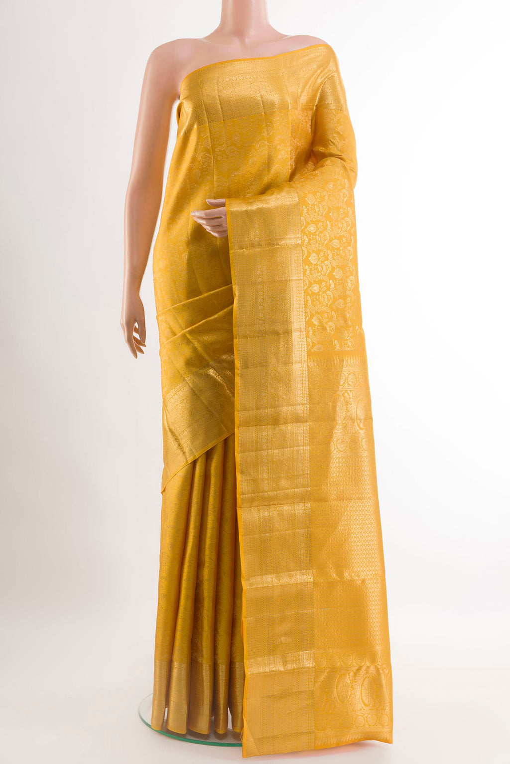 Yellow Kanchipuram Silk Saree with Zari Brocade on the body and Zari Border.  displayed on a mannequin