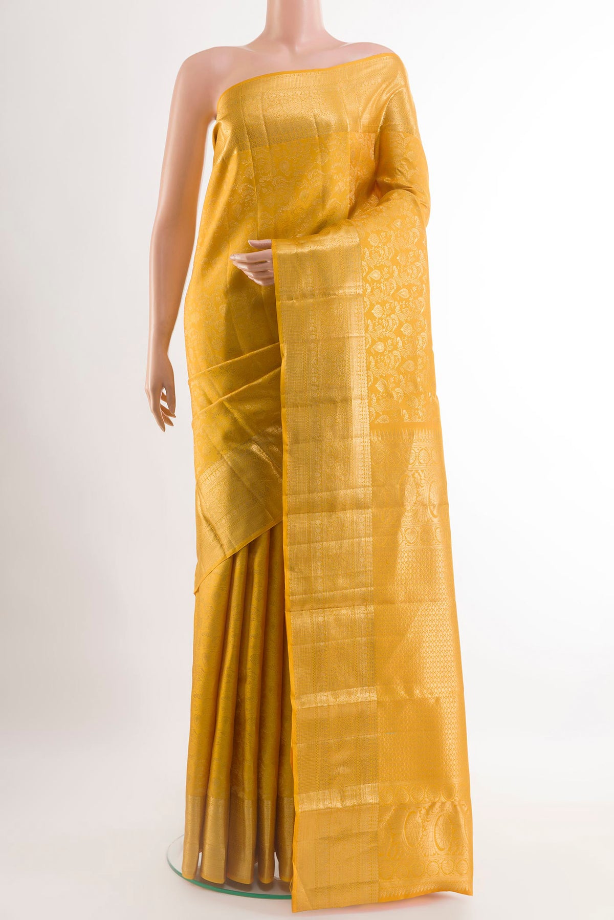 Yellow Kanchipuram Silk Saree with Zari Brocade on the body and Zari Border.  displayed on a mannequin