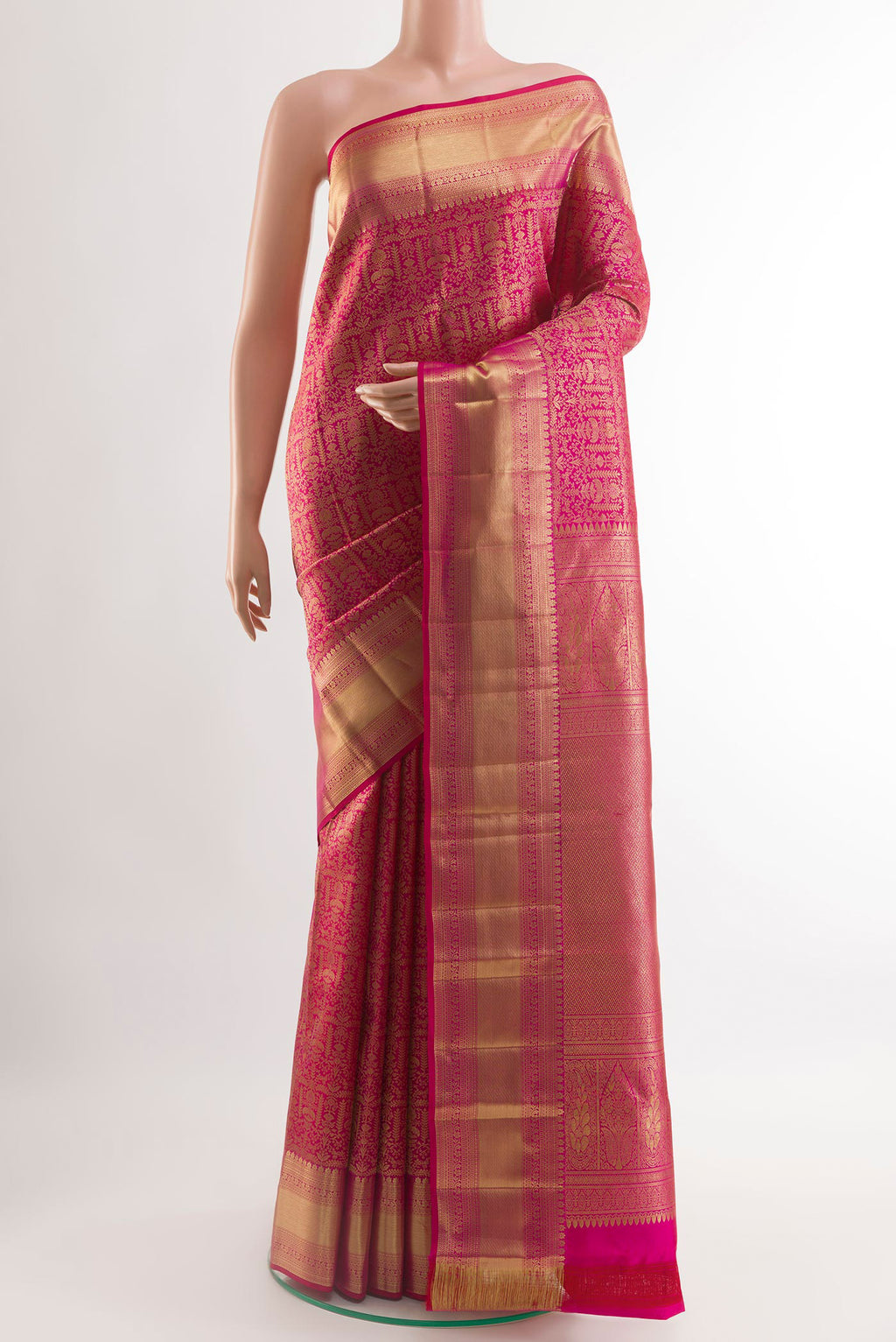 Rani Pink Kanchipuram Silk Saree with Zari Brocade on the body and Zari Border.  displayed on a mannequin