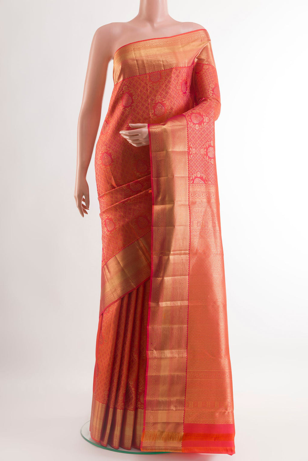 Peach Kanchipuram Silk Saree with Zari Brocade on the body and Zari Border.  displayed on a mannequin