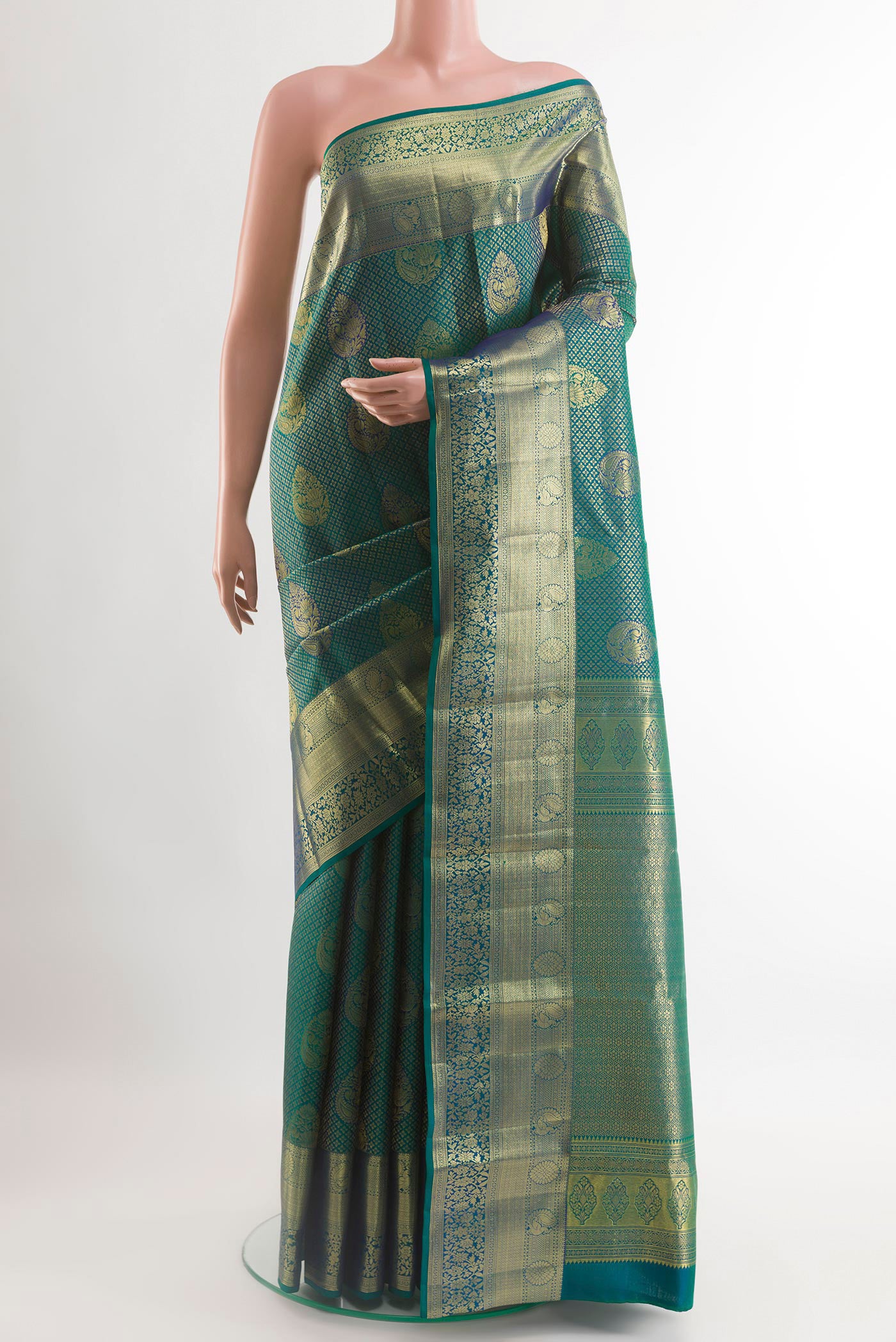 Green Kanchipuram Silk Saree with Zari Brocade on the body and Zari Border.  displayed on a mannequin