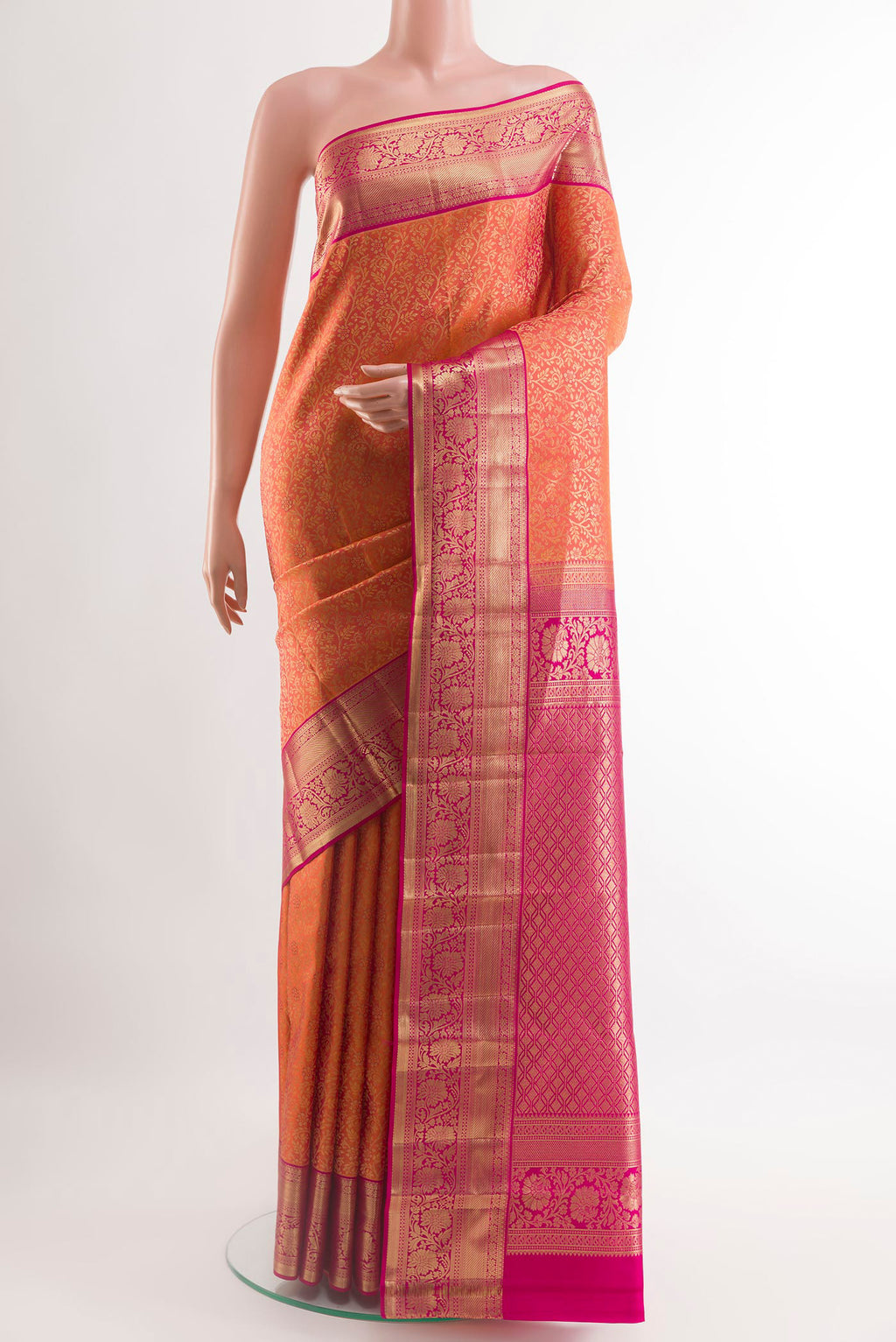 Orange Kanchipuram Silk Saree with Zari Brocade on the body and Zari Border.  displayed on a mannequin