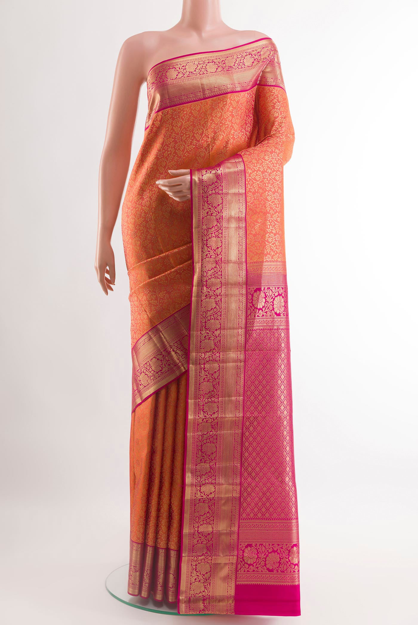 Orange Kanchipuram Silk Saree with Zari Brocade on the body and Zari Border.  displayed on a mannequin