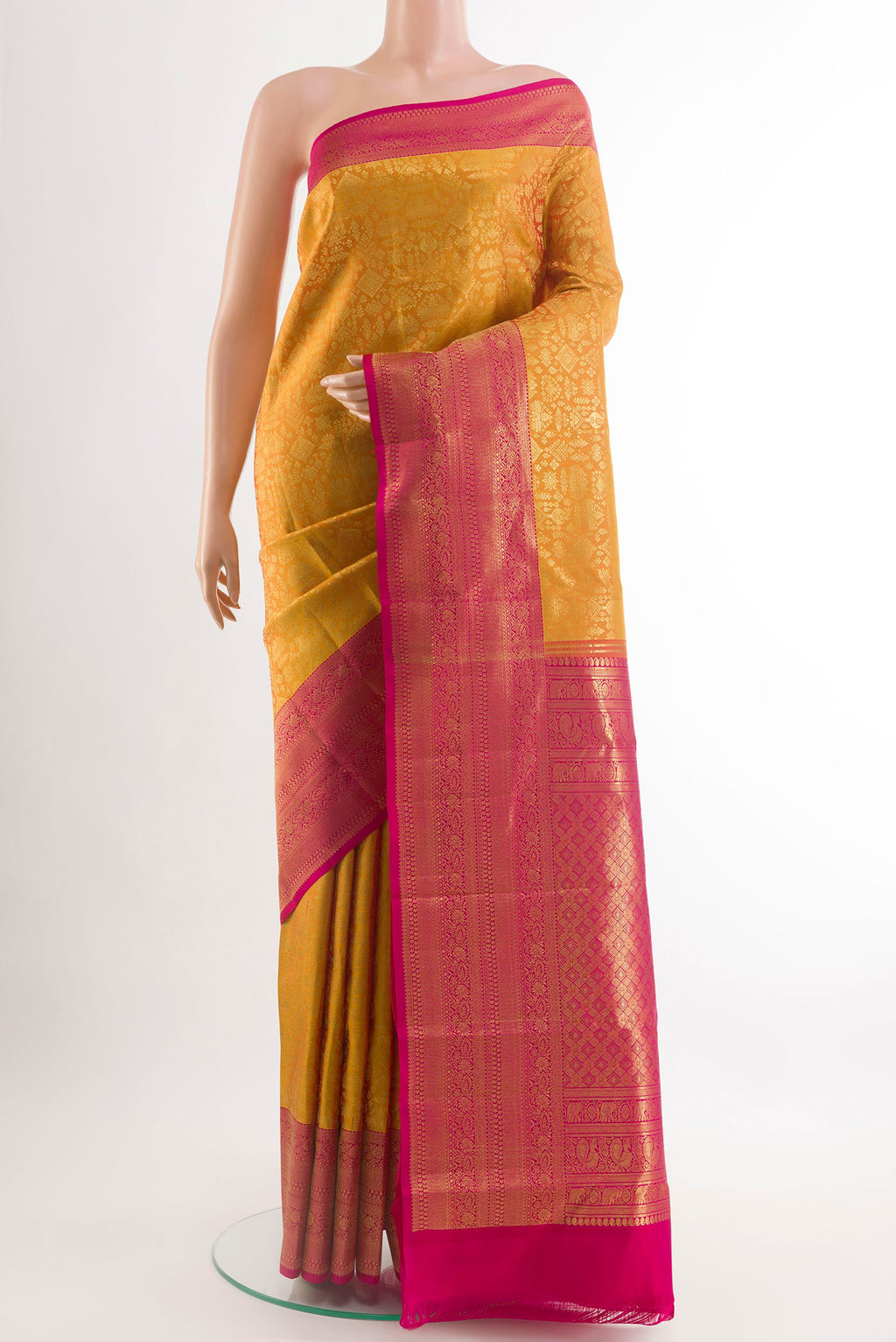 Yellow Kanchipuram Silk Saree with Zari Brocade on the body and Zari Border.  displayed on a mannequin