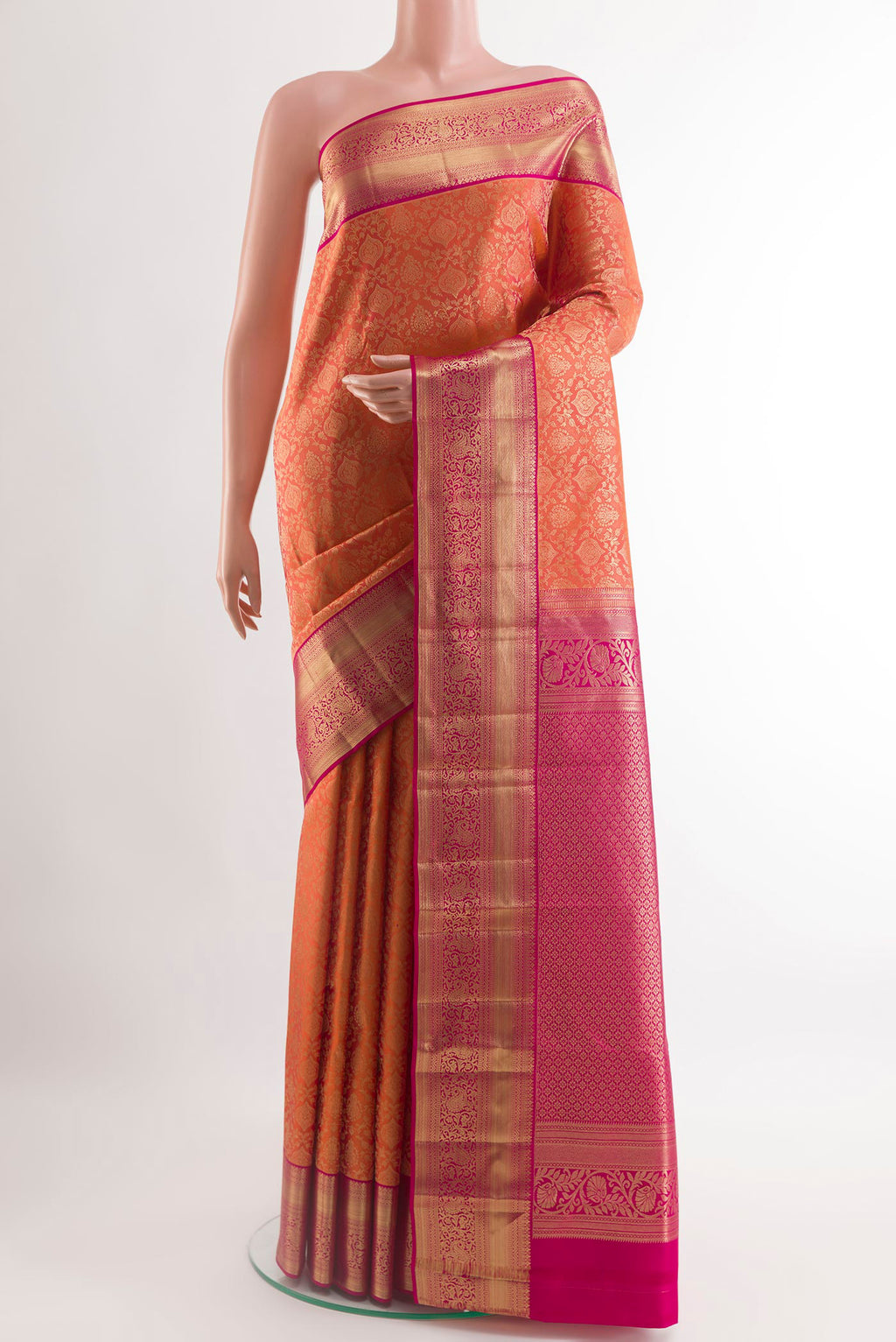Orange Kanchipuram Silk Saree with Zari Brocade on the body and Zari Border.  displayed on a mannequin