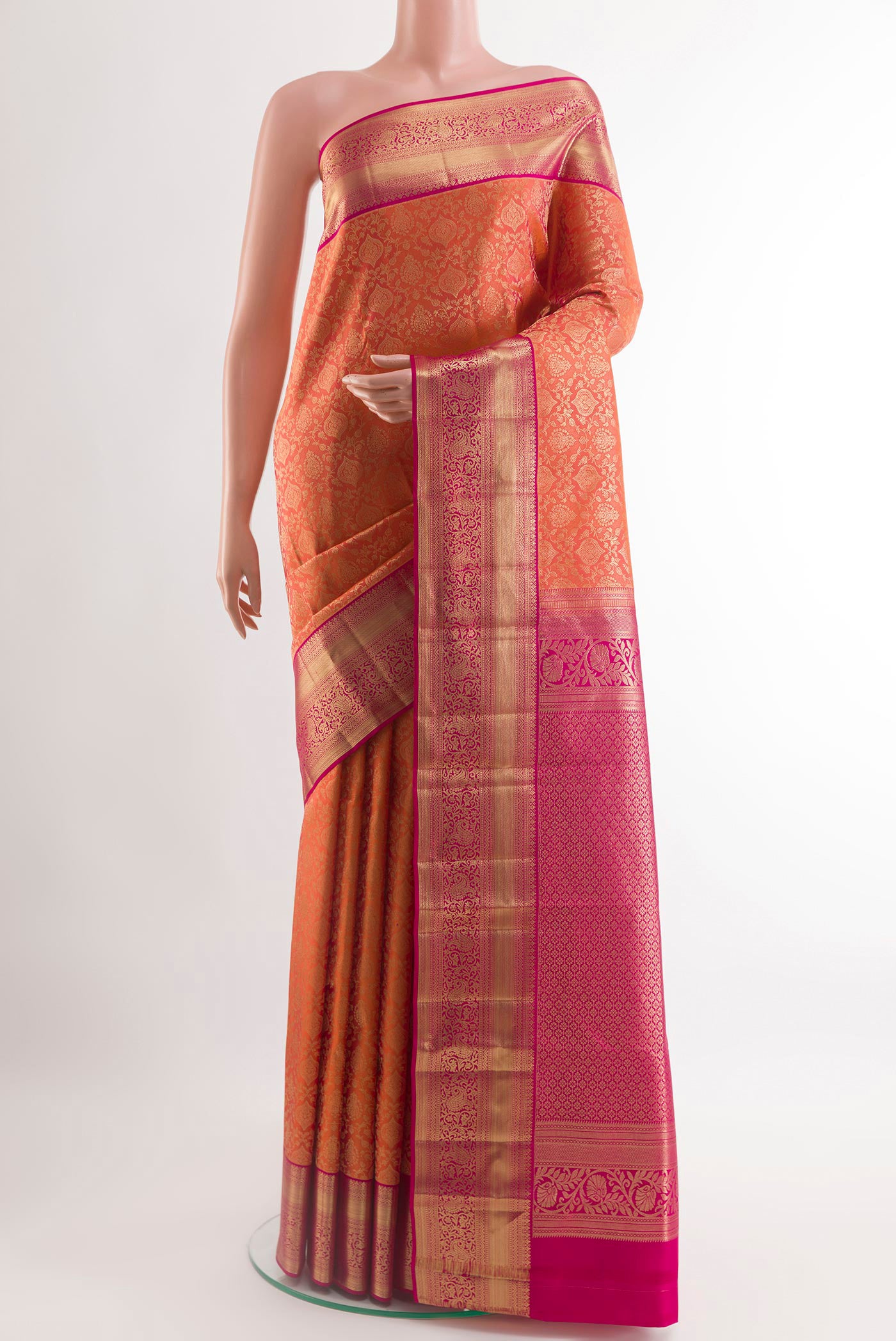 Orange Kanchipuram Silk Saree with Zari Brocade on the body and Zari Border.  displayed on a mannequin
