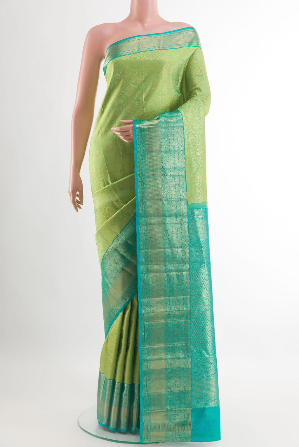 Green Kanchipuram Silk Saree with Zari Brocade on the body and Zari Border.  displayed on a mannequin