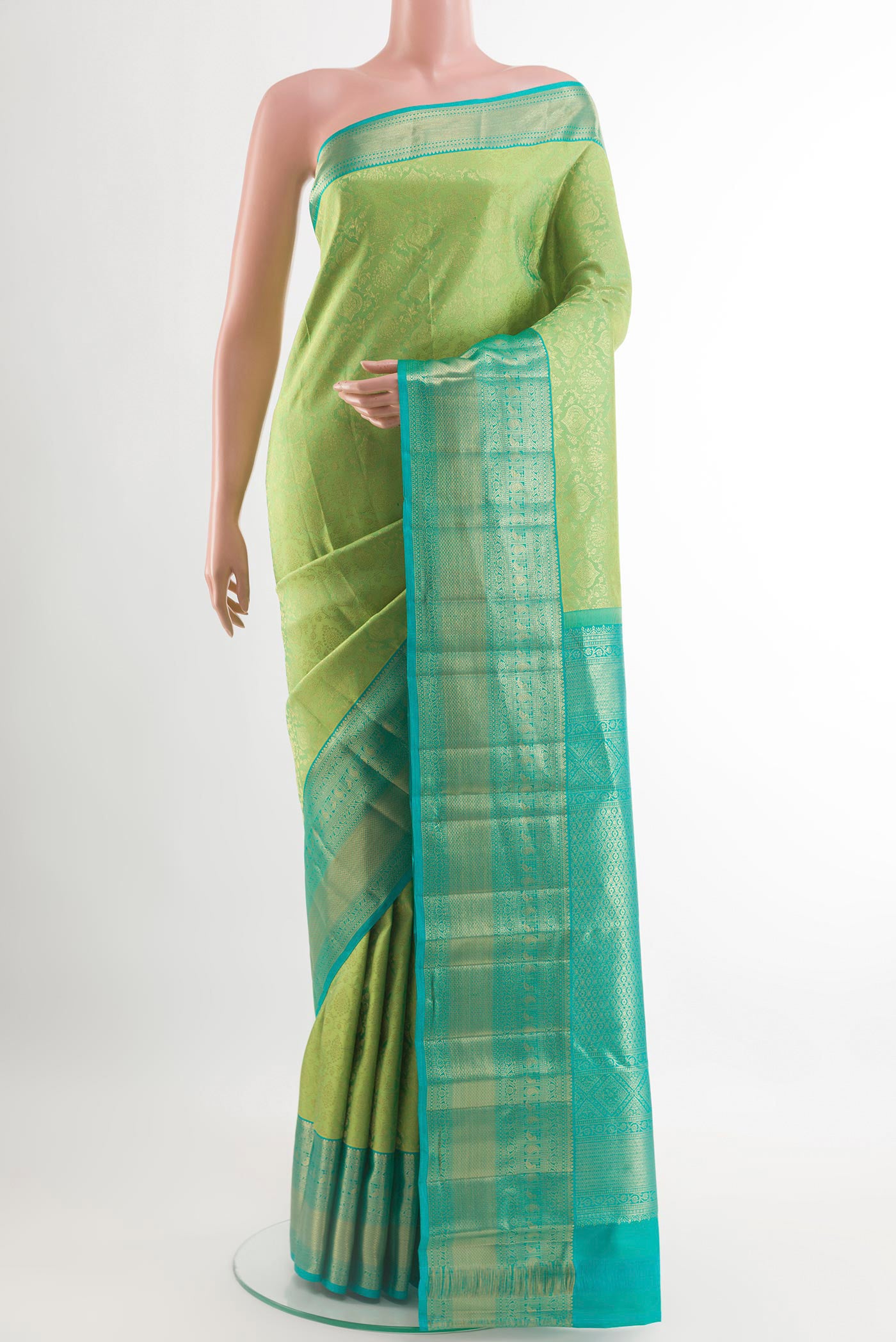 Green Kanchipuram Silk Saree with Zari Brocade on the body and Zari Border.  displayed on a mannequin