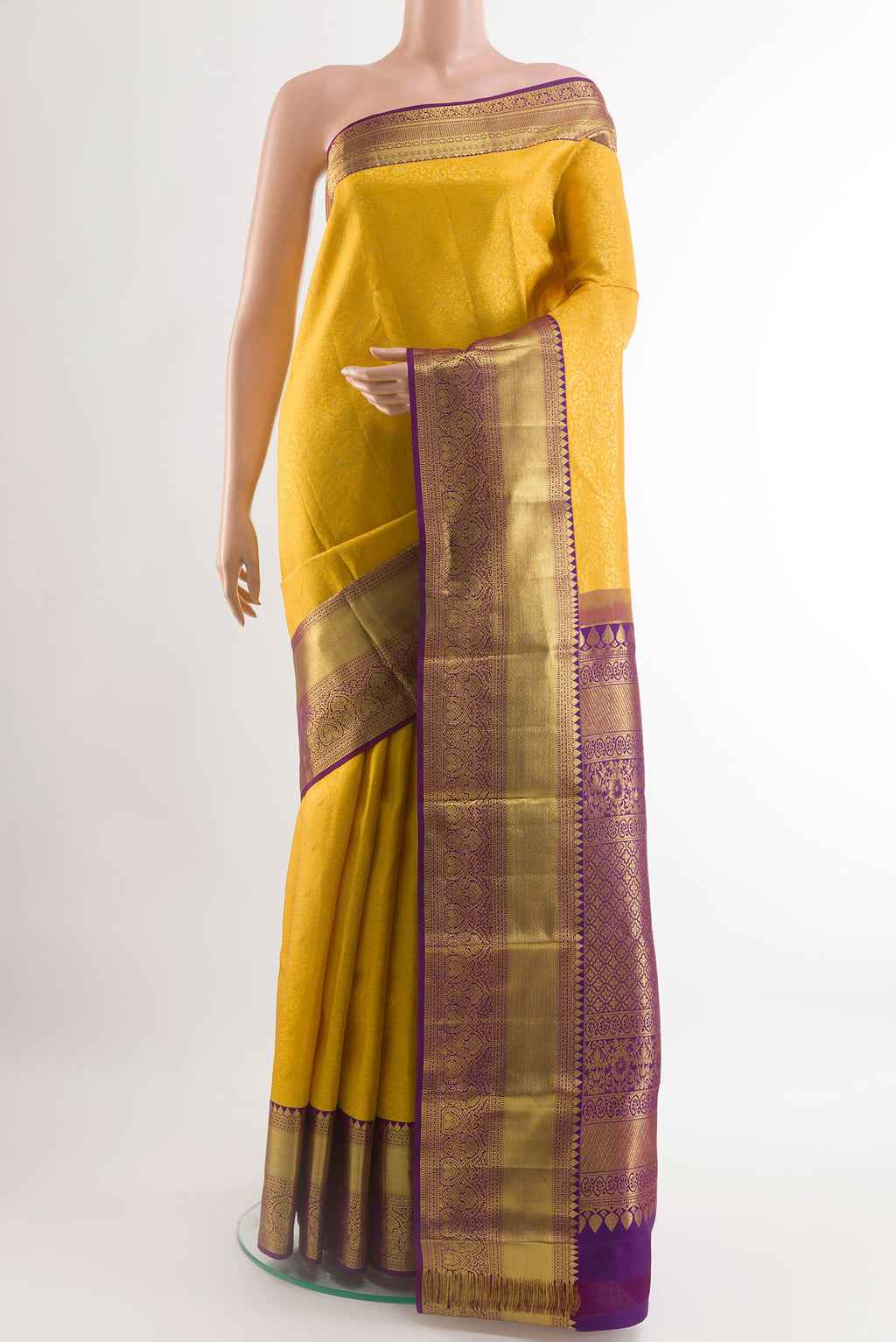 Yellow Kanchipuram Silk Saree with Zari Brocade on the body and Zari Border.  displayed on a mannequin
