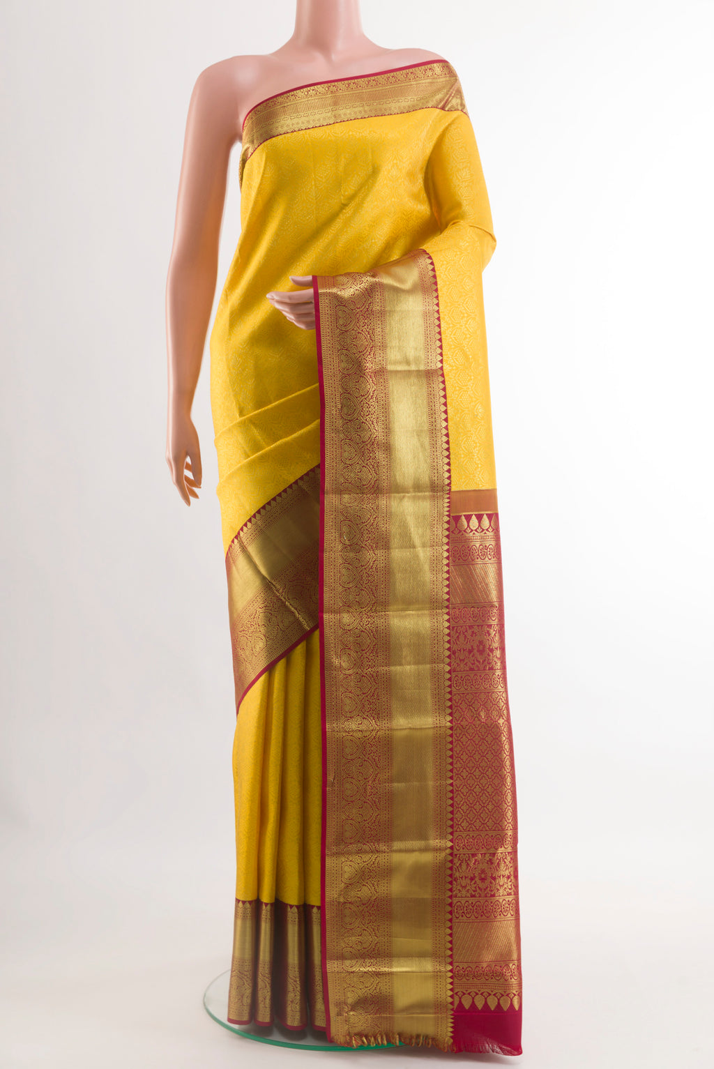 Yellow Kanchipuram Silk Saree with Zari Brocade on the body and Zari Border.  displayed on a mannequin