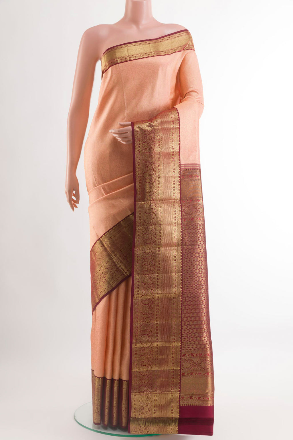 Peach Kanchipuram Silk Saree with Zari Brocade on the body and Zari Border.  displayed on a mannequin