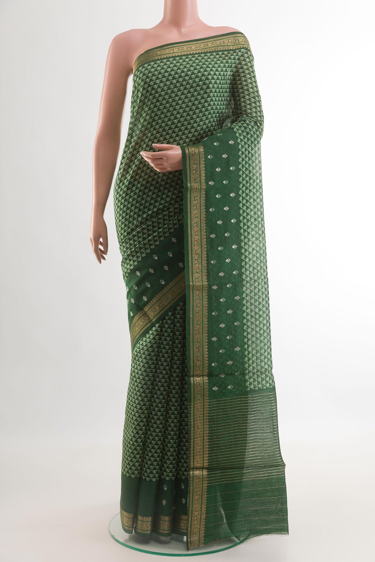 Green Tussar Silk Saree with Printed design on the body and Zari Border.  displayed on a mannequin
