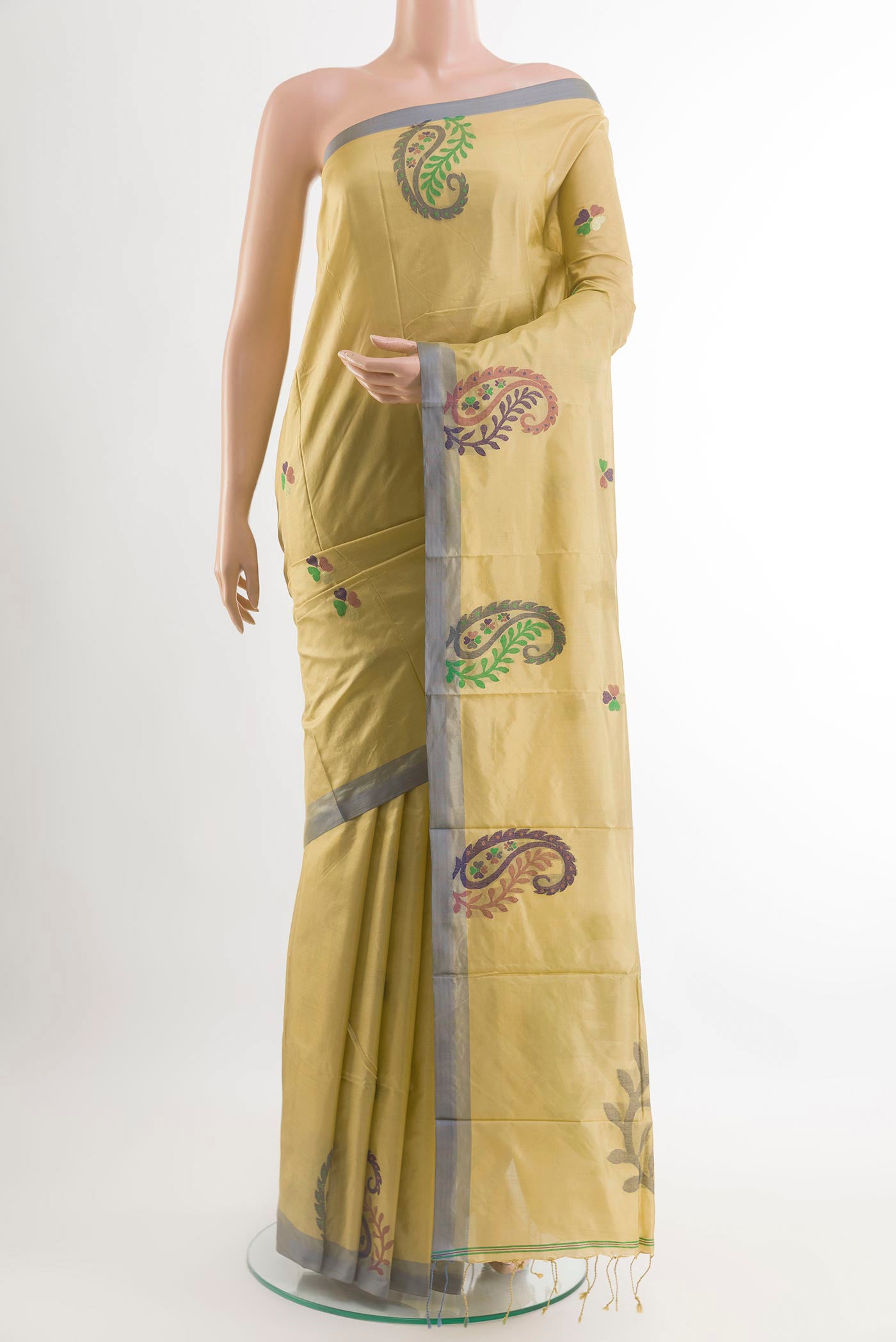 Beige Kanjivaram Silk Saree with Thread Butta on the body and Embroidery Border.  displayed on a mannequin