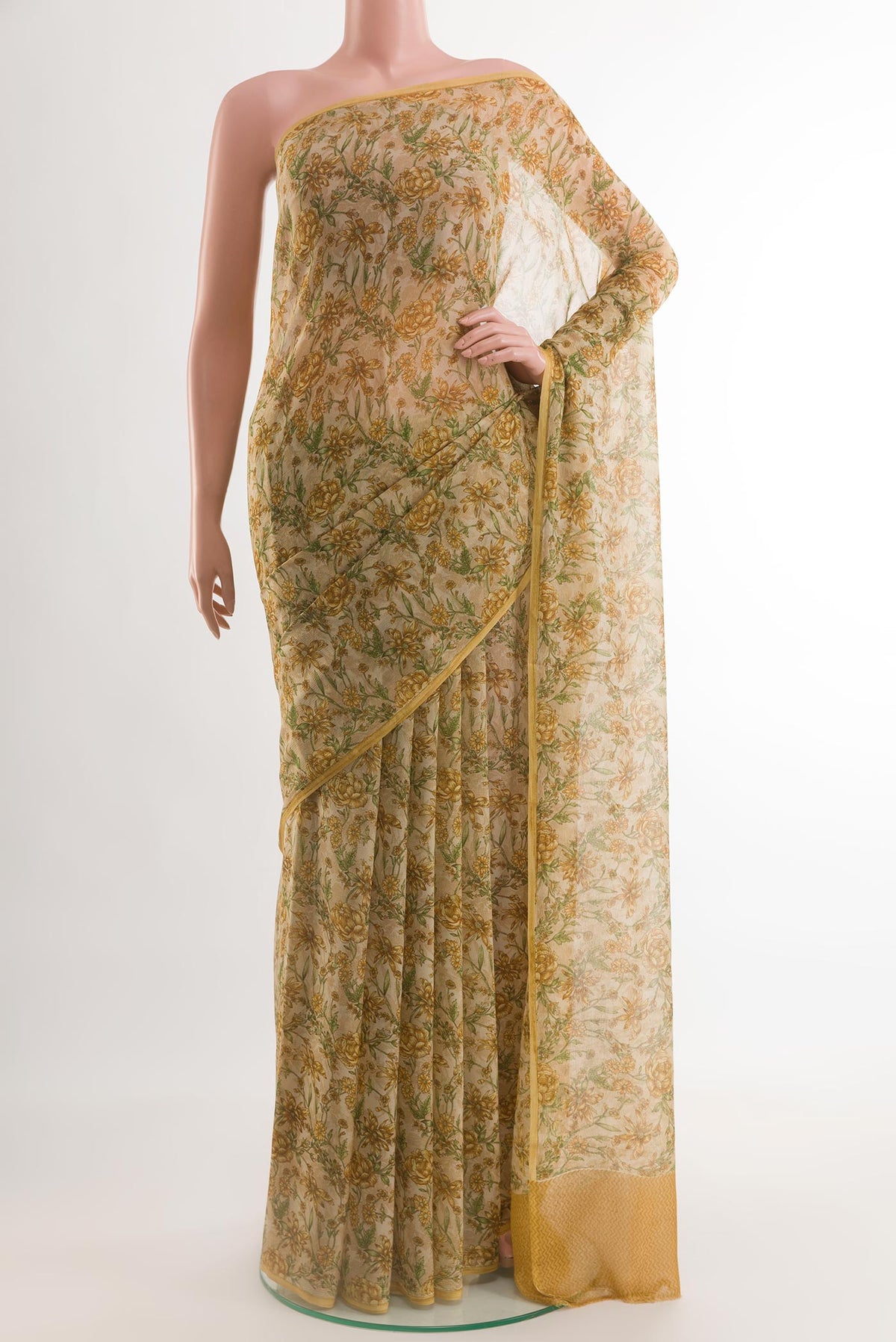 Cream Chiffon Saree with Printed design on the body and Plain Border.  displayed on a mannequin