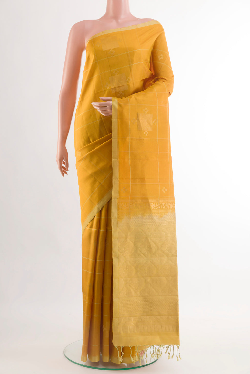 Yellow Soft Silk Saree with Zari Butta on the body and Zari Border.  displayed on a mannequin