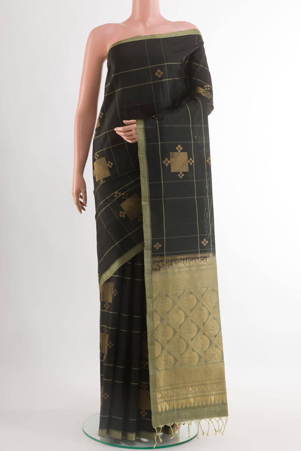 Black Soft Silk Saree with Zari Butta on the body and Zari Border.  displayed on a mannequin