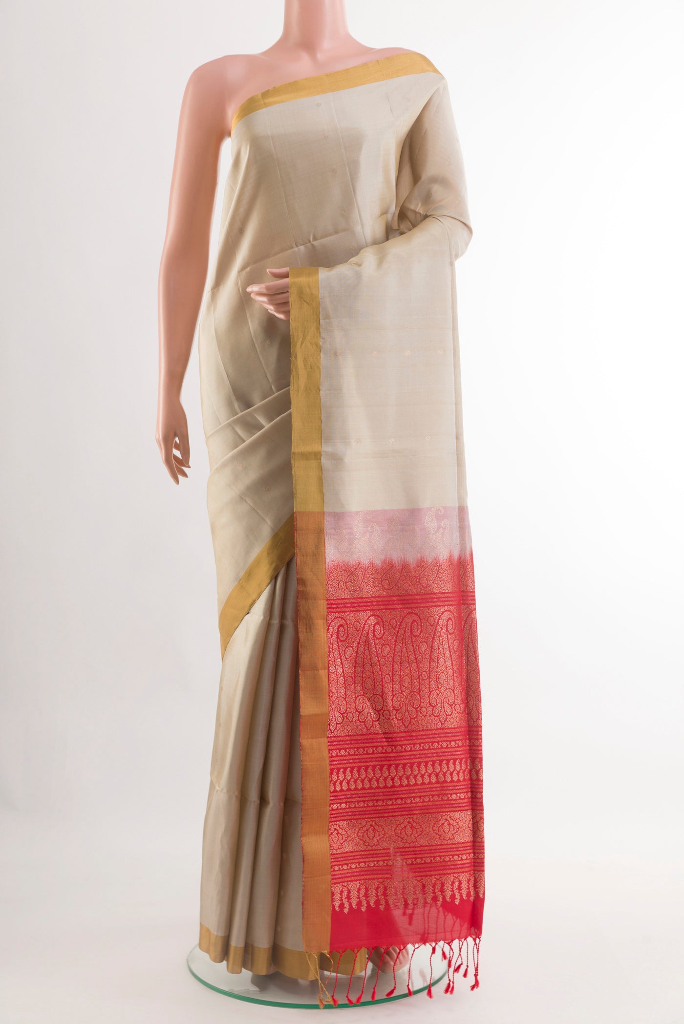 Off White Soft Silk Saree with Zari Butta on the body and Zari Border.  displayed on a mannequin