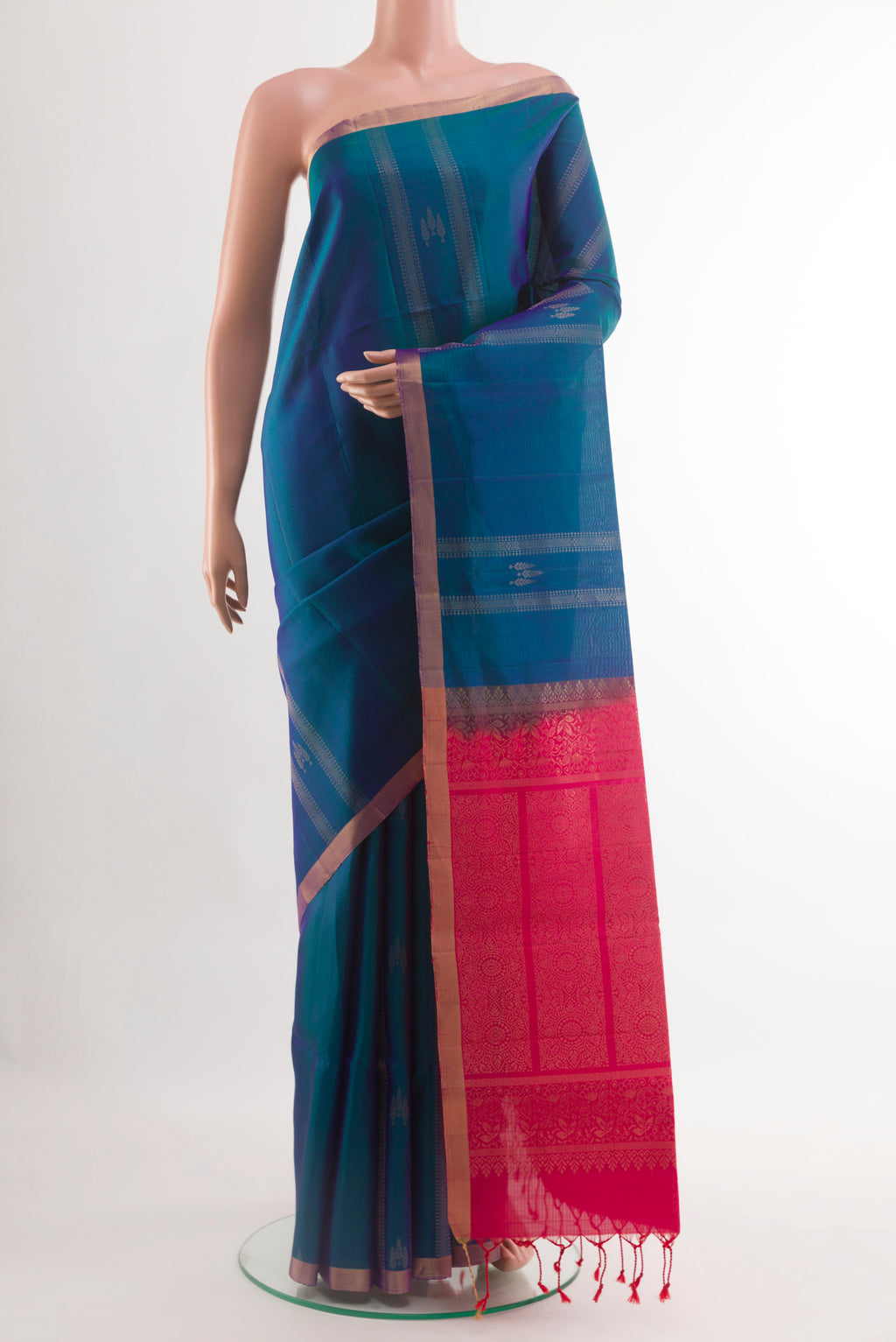 Peacock Blue Soft Silk Saree with Zari Butta on the body and Zari Border.  displayed on a mannequin