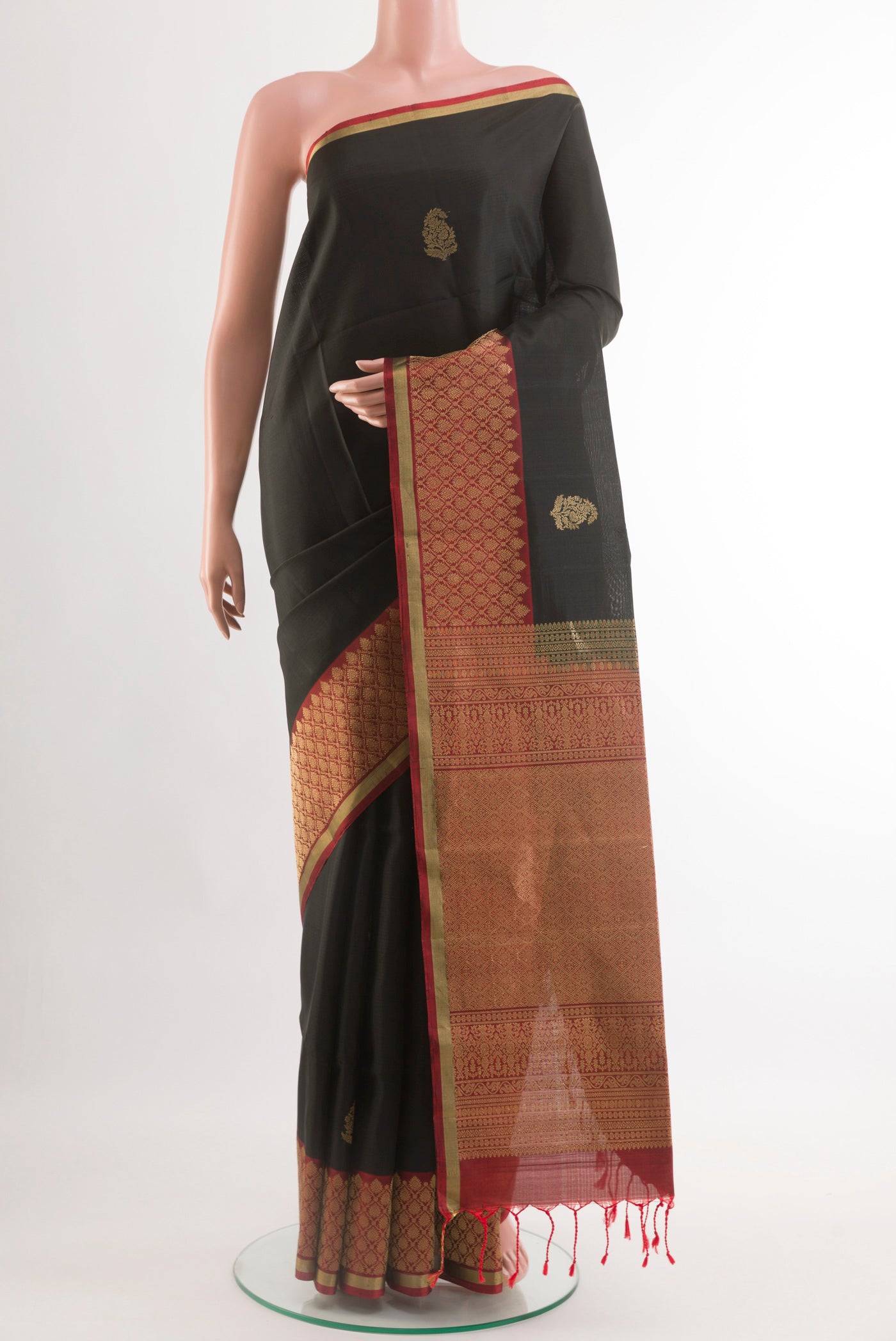 Black Soft Silk Saree with Zari Butta on the body and Zari Border.  displayed on a mannequin