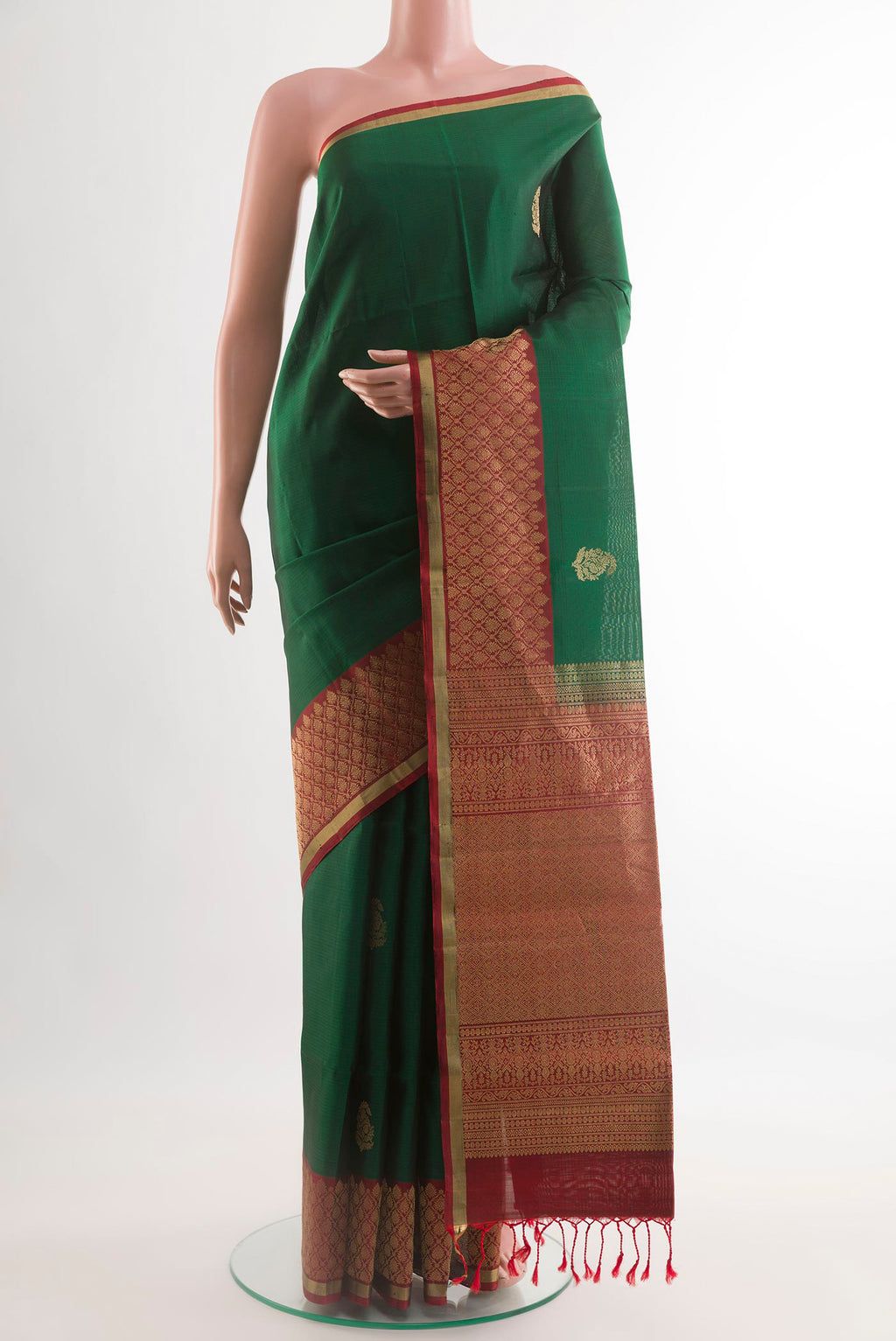 Green Soft Silk Saree with Zari Butta on the body and Zari Border.  displayed on a mannequin