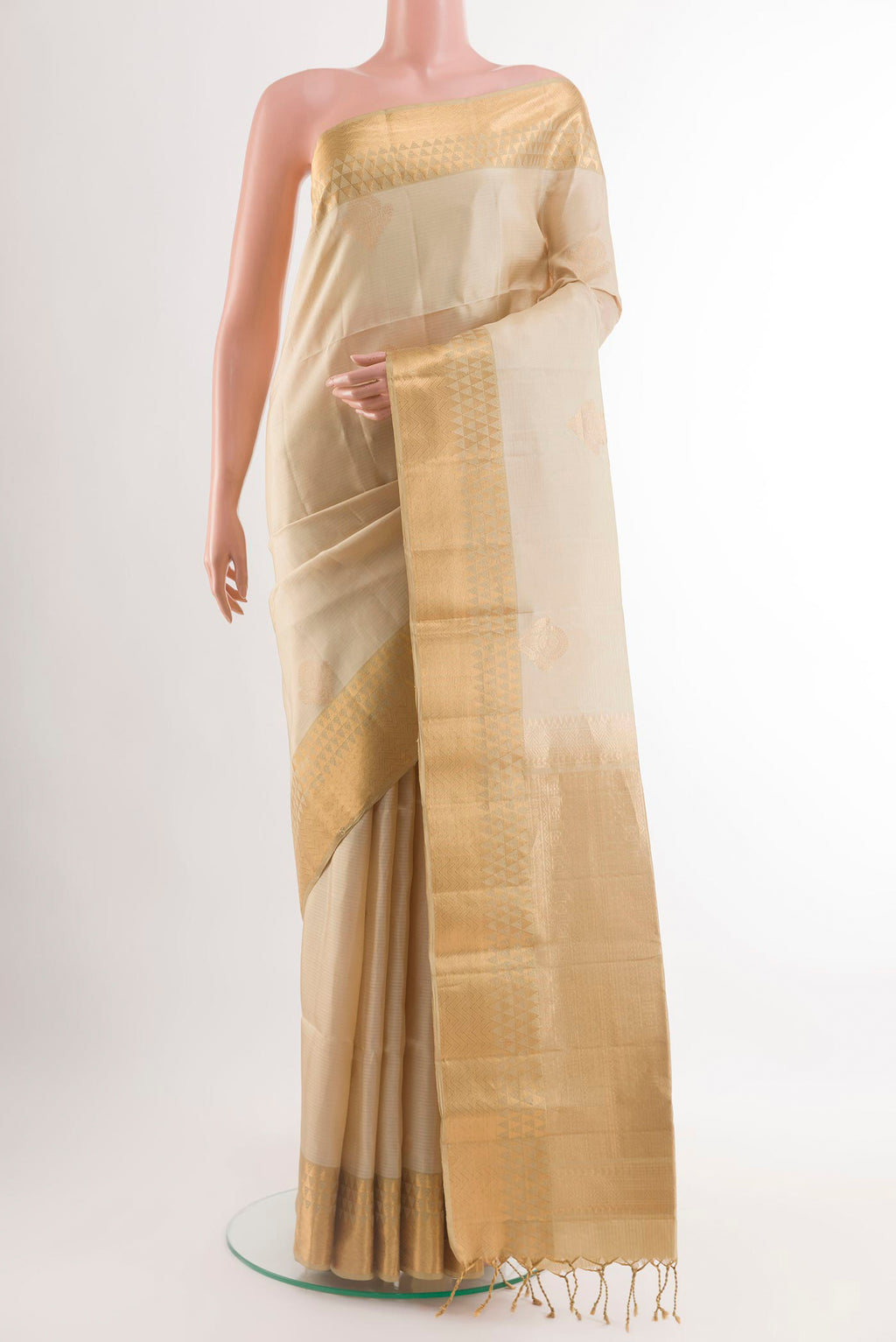 Cream Soft Silk Saree with Zari Butta on the body and Zari Border.  displayed on a mannequin