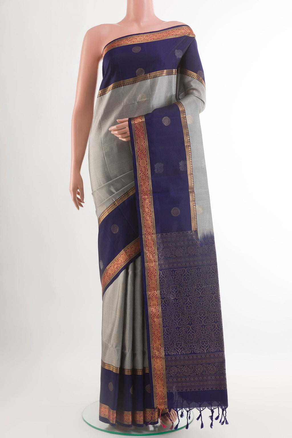Grey Soft Silk Saree with Zari Butta on the body and Zari Border.  displayed on a mannequin