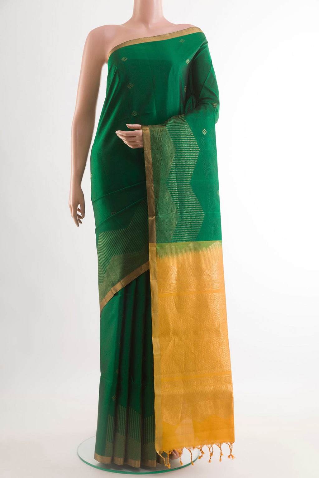Green Soft Silk Saree with Zari Butta on the body and Zari Border.  displayed on a mannequin