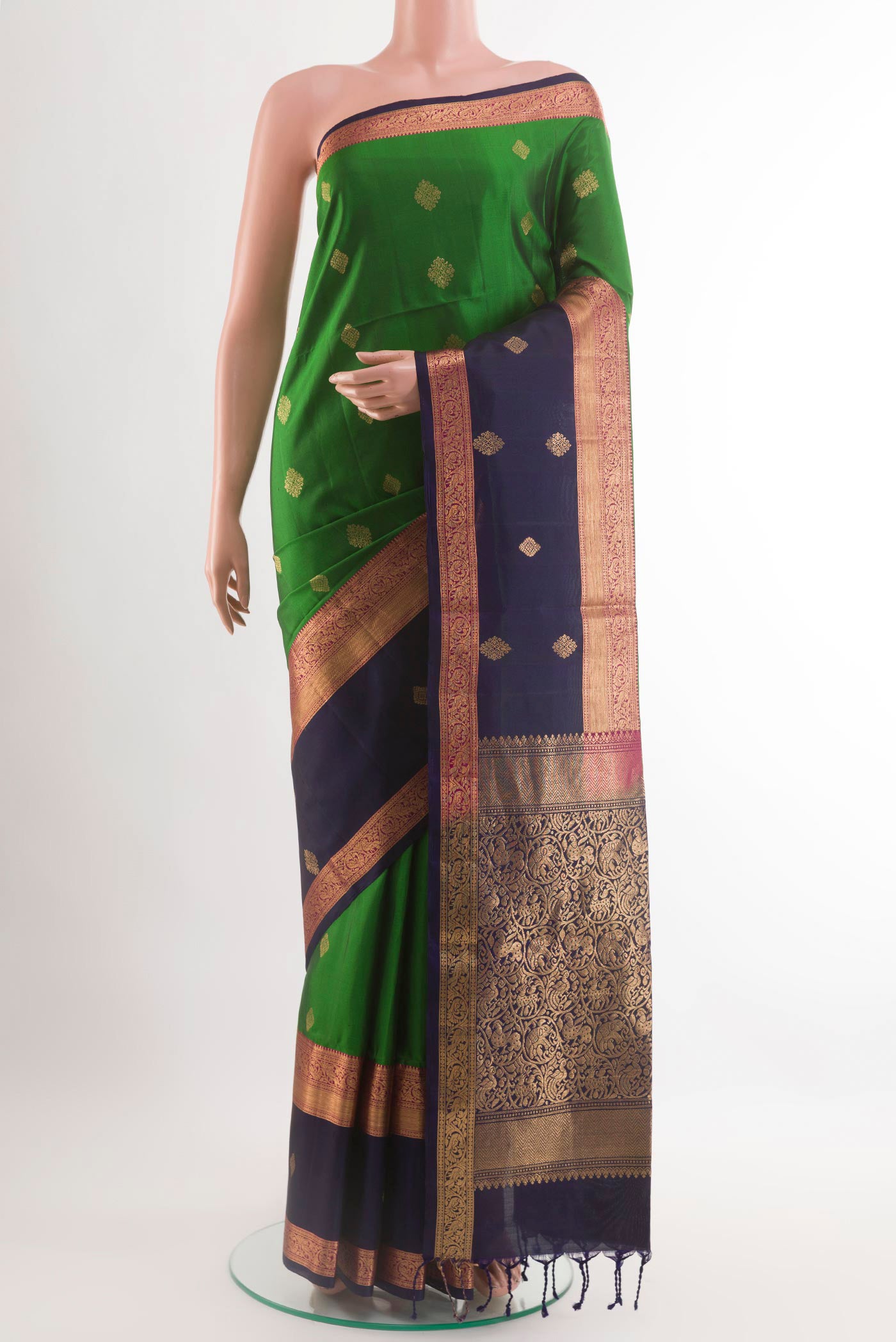 Green Soft Silk Saree with Zari Butta on the body and Zari Border.  displayed on a mannequin