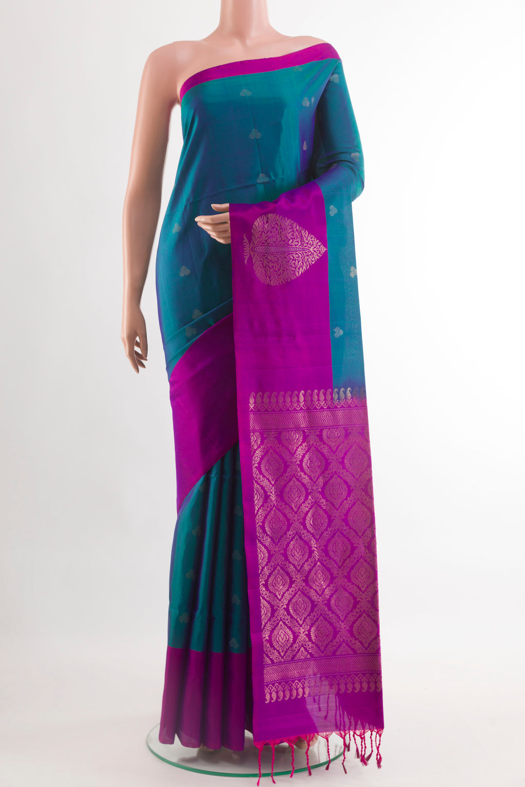 Peacock Blue Soft Silk Saree with Zari Butta on the body and Zari Border.  displayed on a mannequin