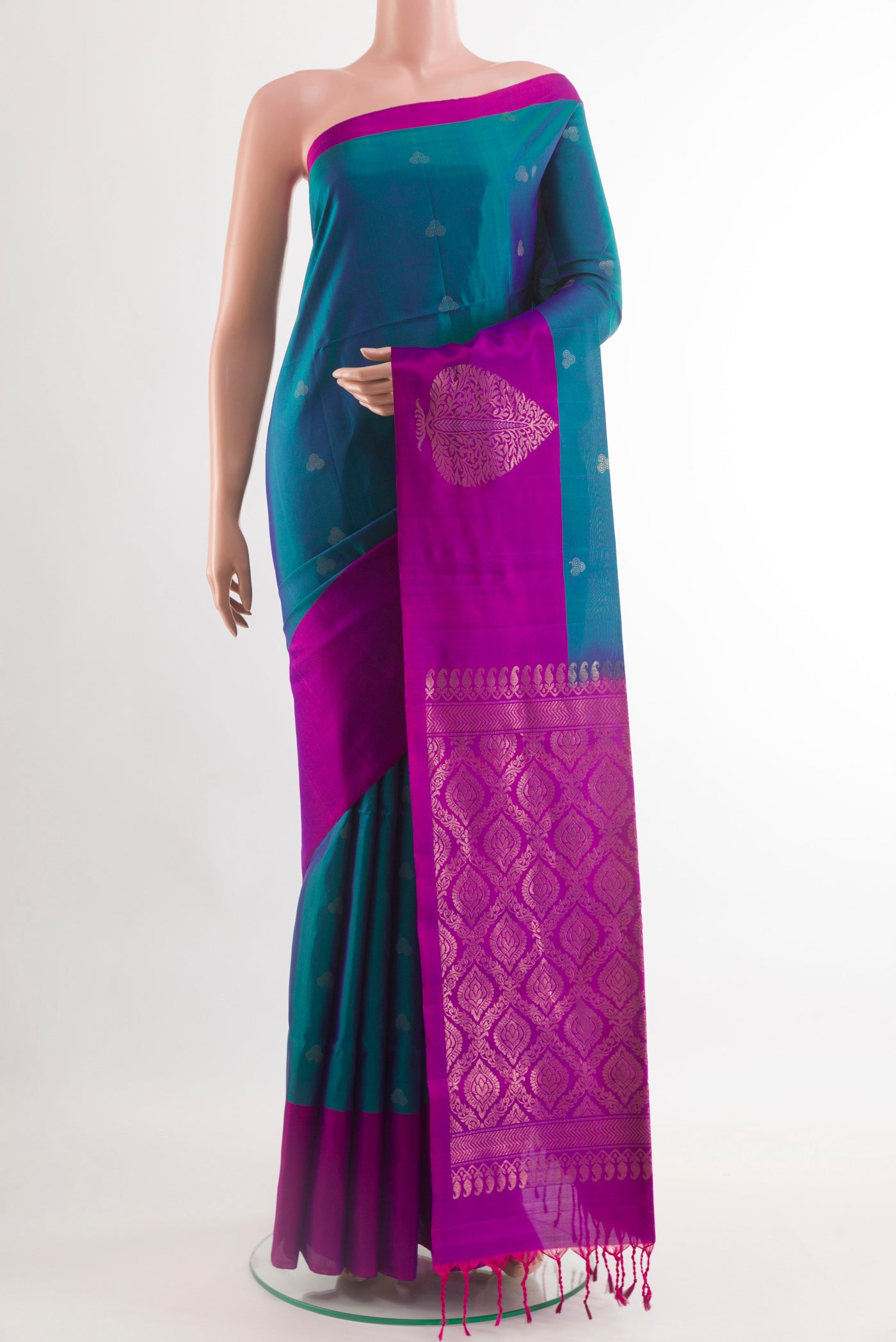 Peacock Blue Soft Silk Saree with Zari Butta on the body and Zari Border.  displayed on a mannequin