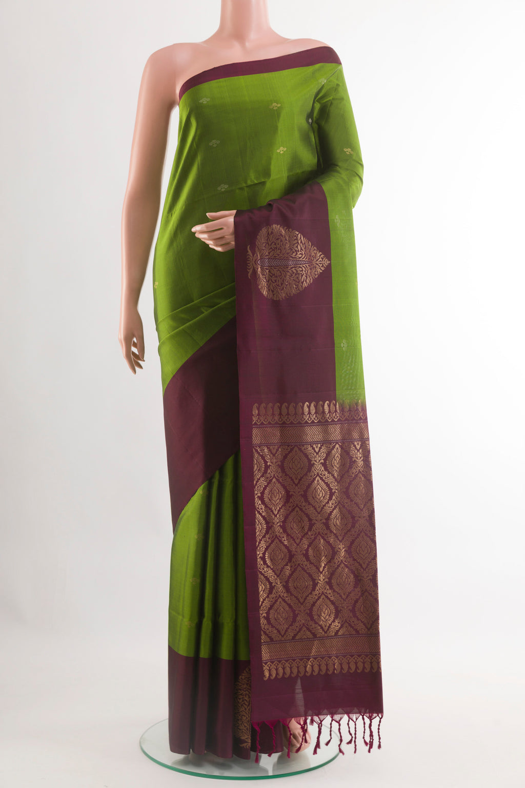 Green Soft Silk Saree with Zari Butta on the body and Zari Border.  displayed on a mannequin