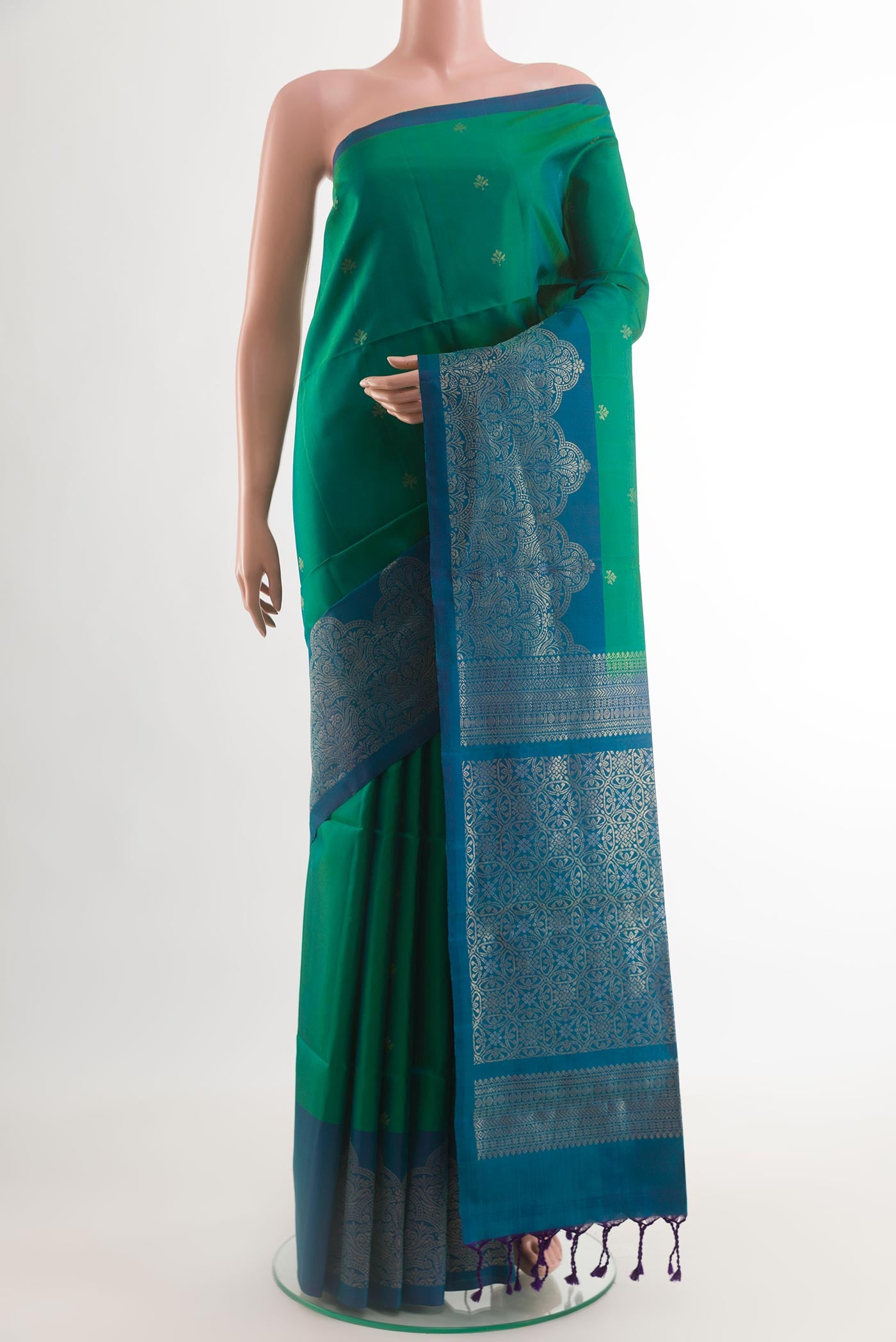 Green Soft Silk Saree with Zari Butta on the body and Zari Border.  displayed on a mannequin