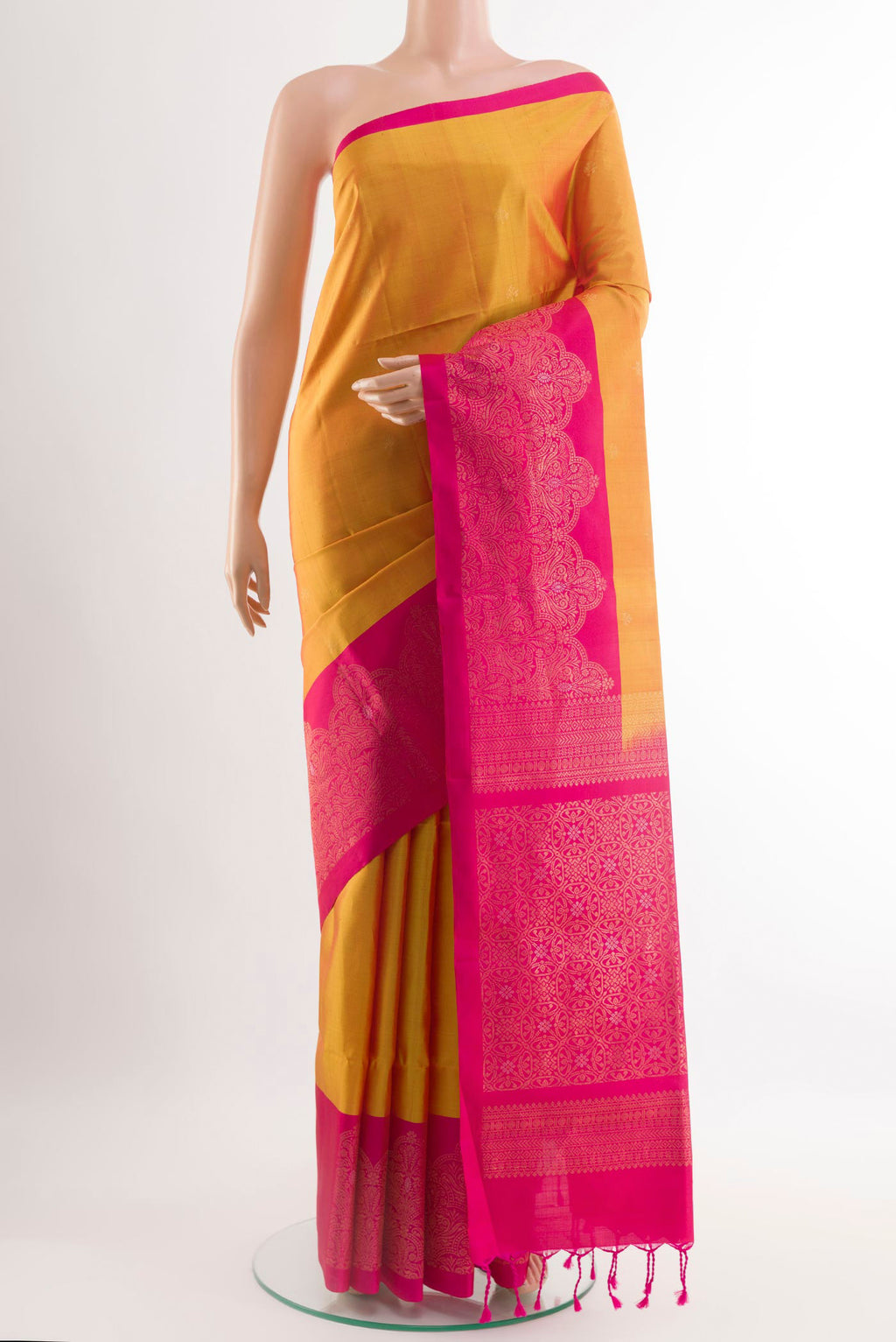 Yellow Soft Silk Saree with Zari Butta on the body and Zari Border.  displayed on a mannequin