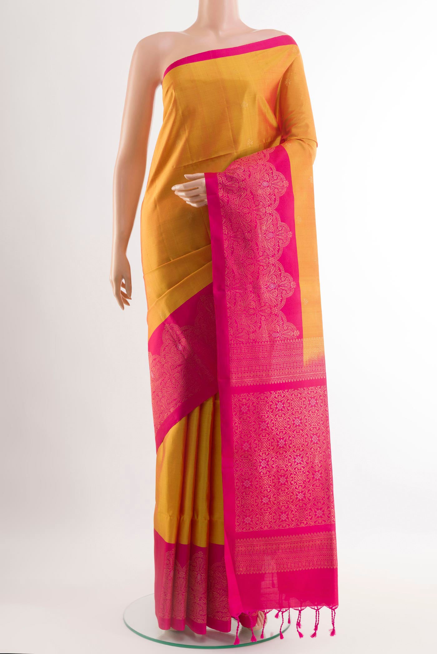 Yellow Soft Silk Saree with Zari Butta on the body and Zari Border.  displayed on a mannequin