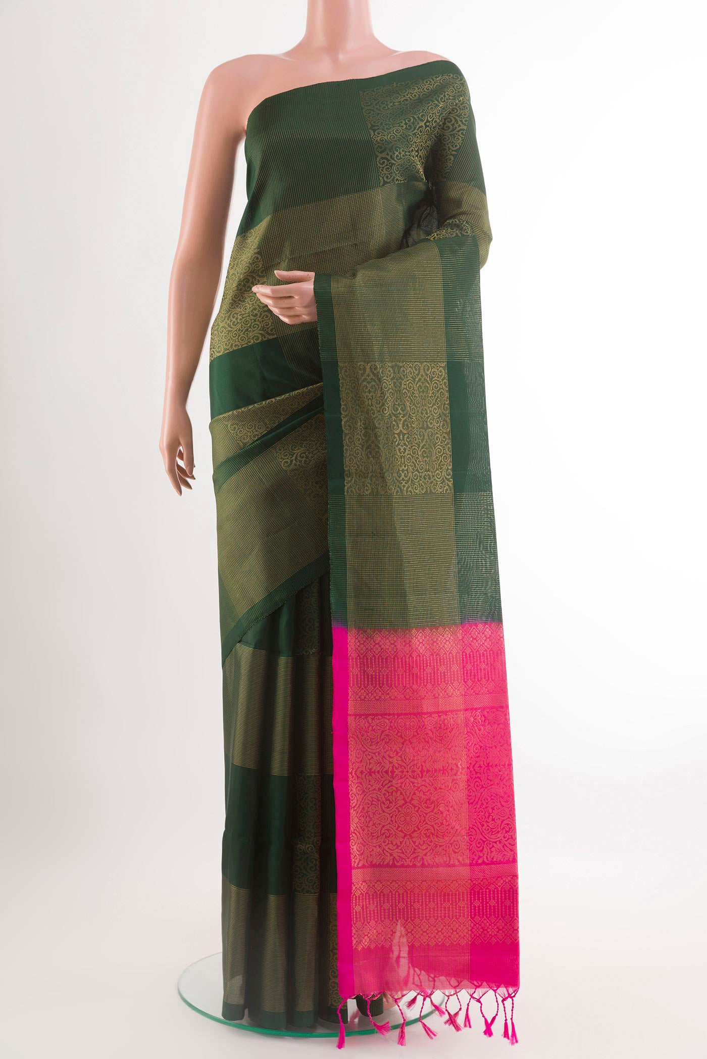 Bottle Green Soft Silk Saree with Zari Butta on the body and Zari Border.  displayed on a mannequin