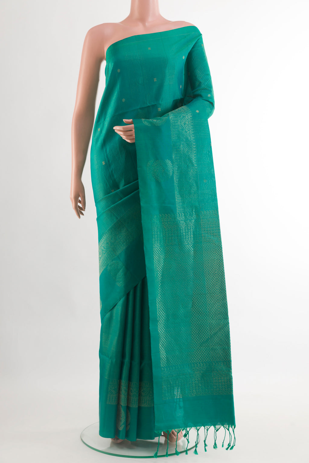 Green Soft Silk Saree with Zari Butta on the body and Zari Border.  displayed on a mannequin