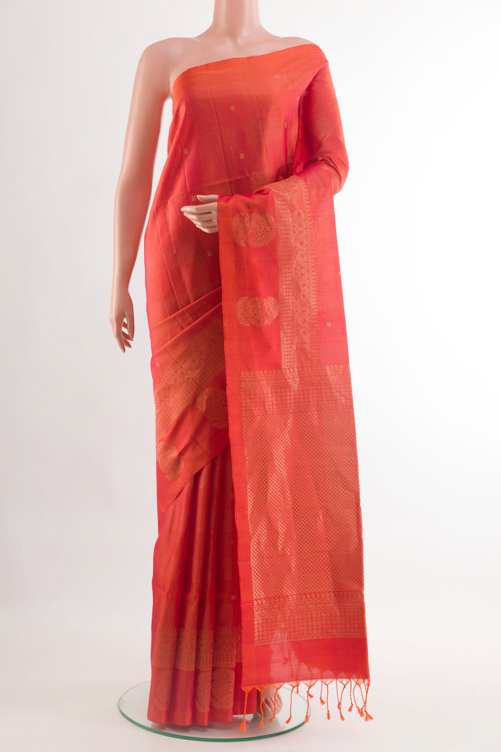 Orange Soft Silk Saree with Zari Butta on the body and Zari Border.  displayed on a mannequin