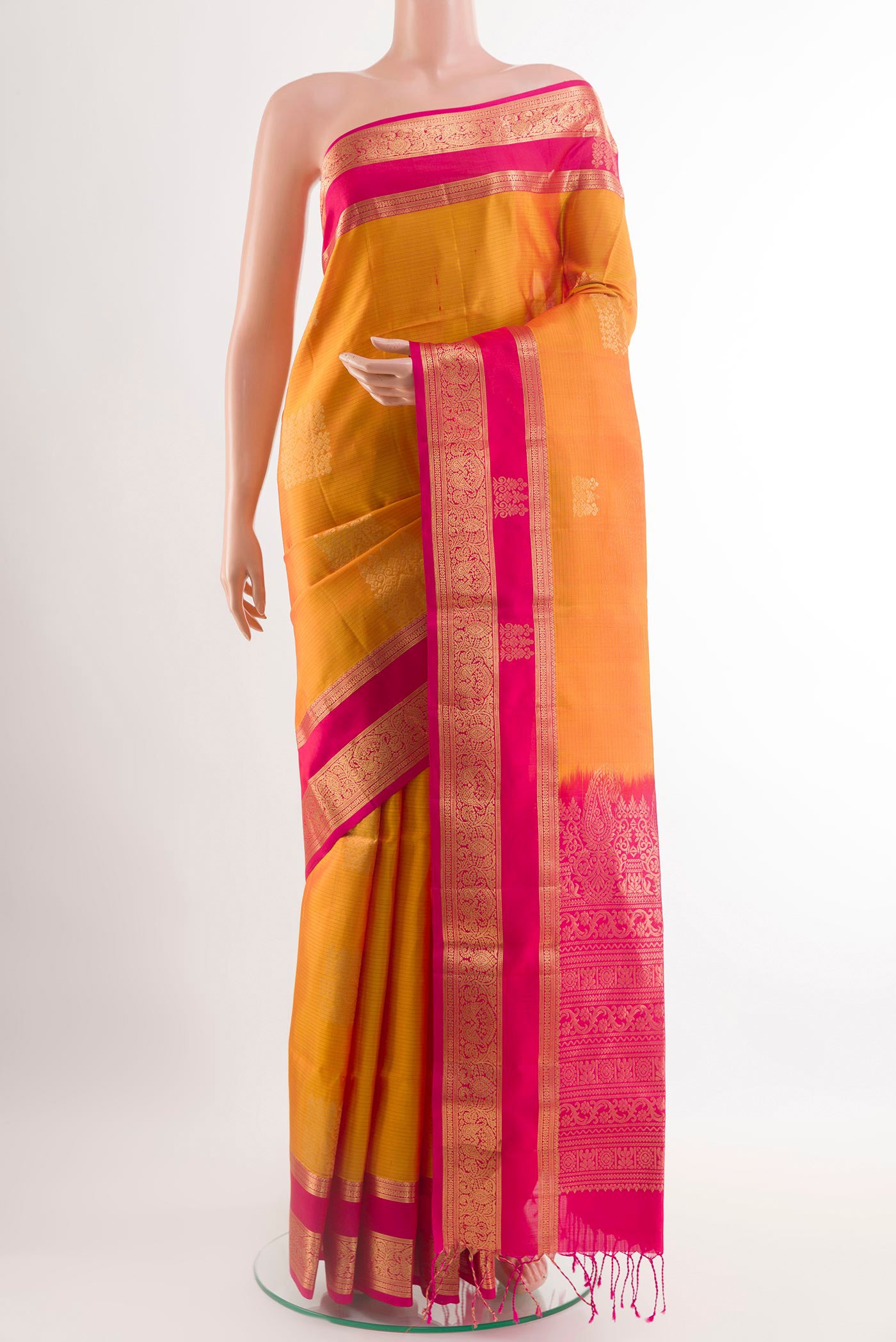 Yellow Soft Silk Saree with Zari Butta on the body and Zari Border.  displayed on a mannequin
