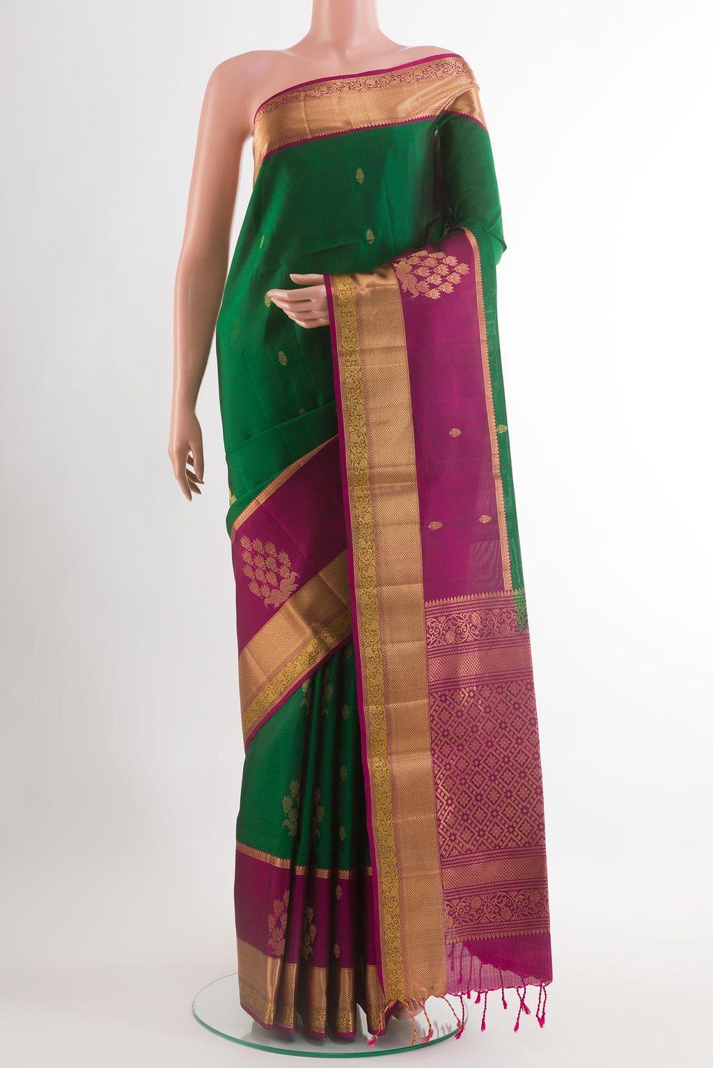 Green Soft Silk Saree with Ikat design on the body and Zari Border.  displayed on a mannequin