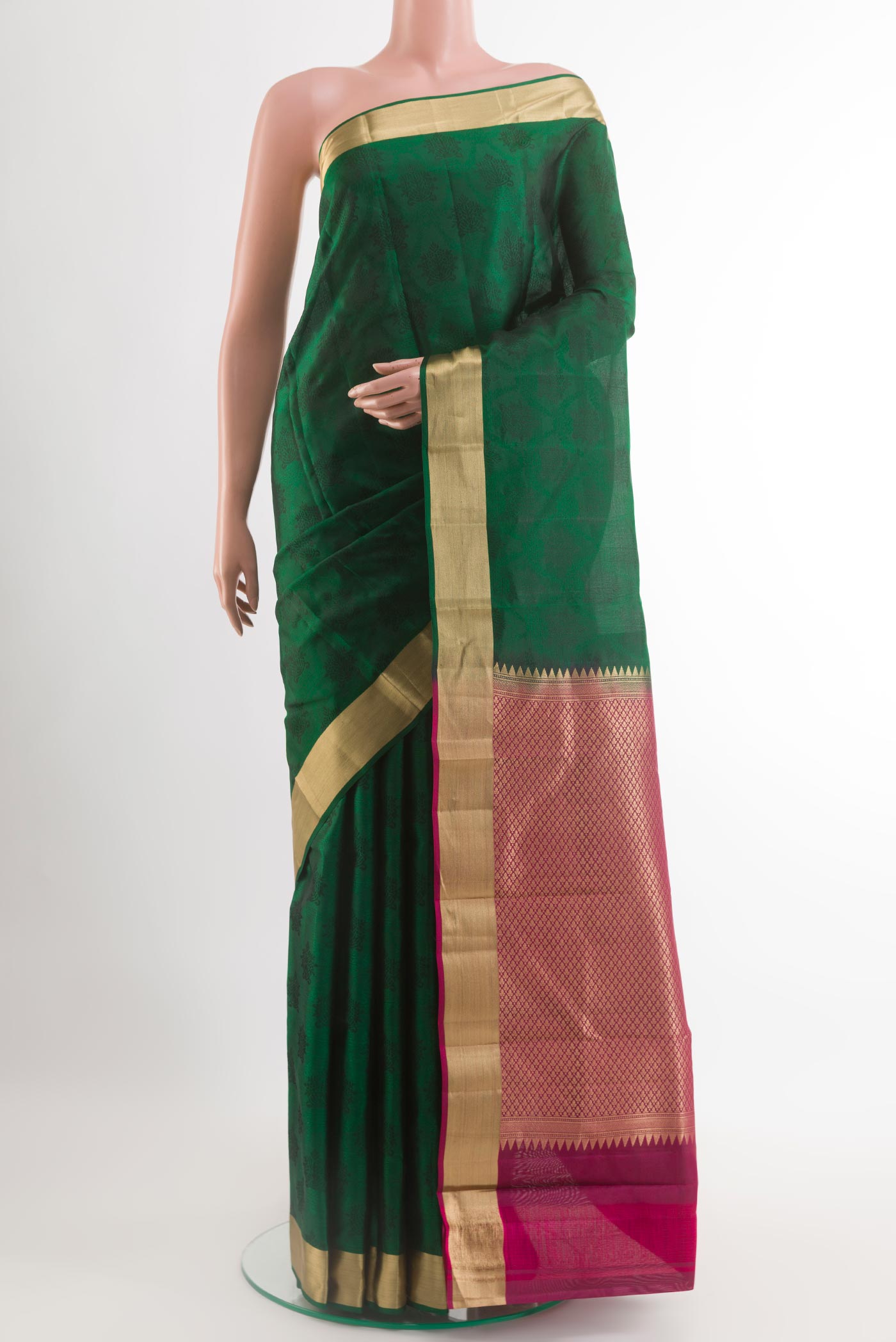 Green Kanjivaram Silk Saree with Jacquard design on the body and Zari Border.  displayed on a mannequin