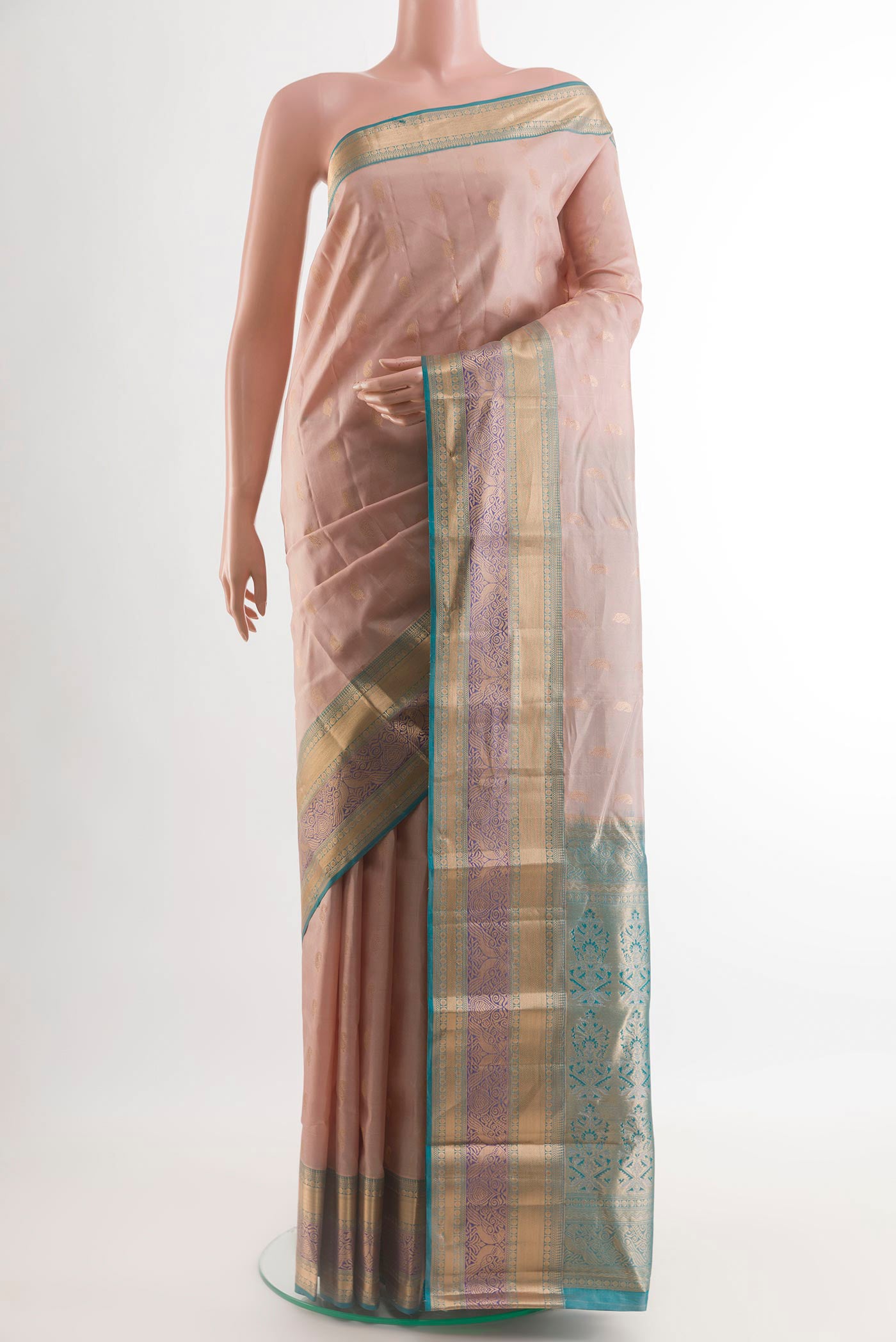 Cream Kanchipuram Silk Saree with Zari Butta on the body and Zari Border.  displayed on a mannequin
