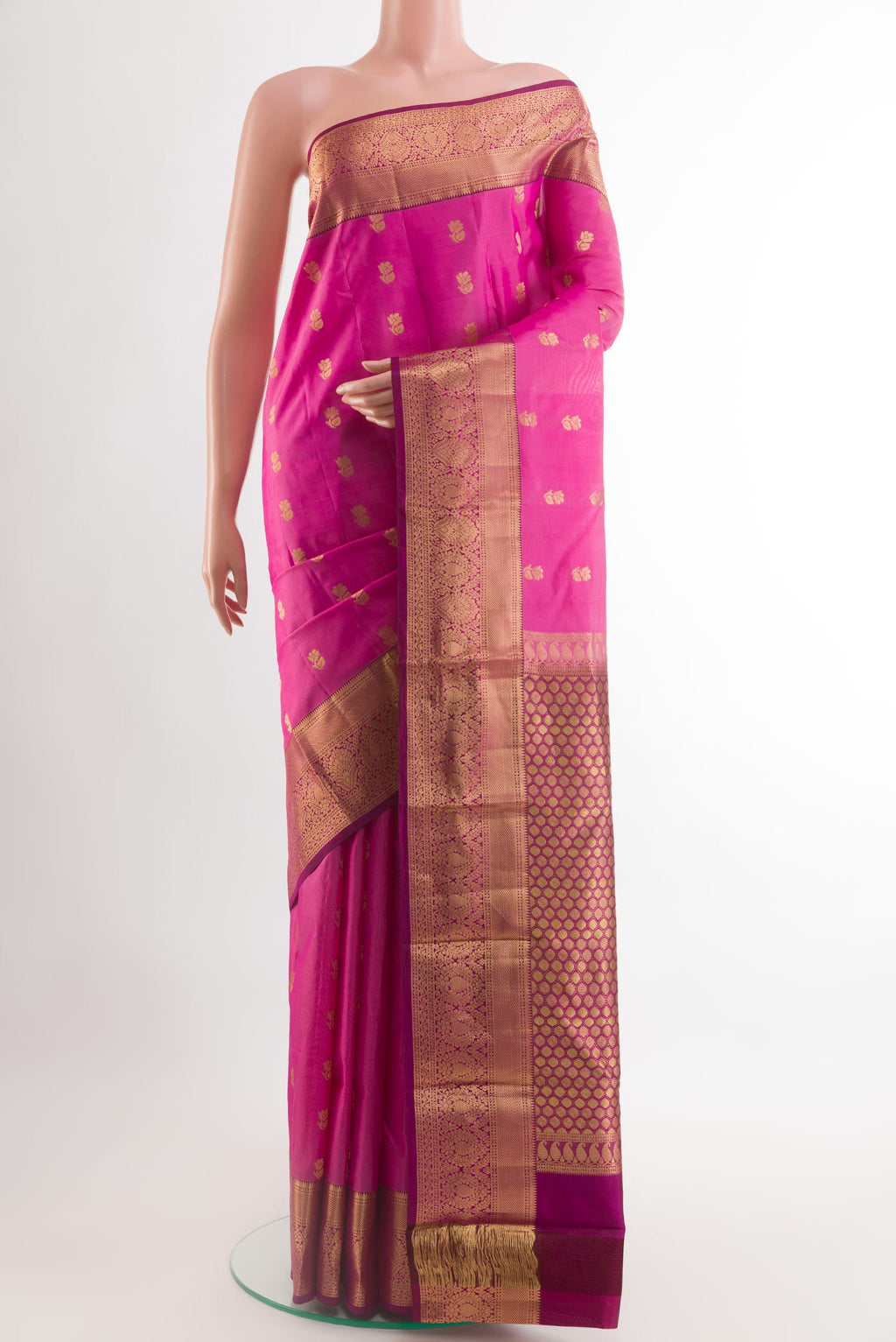 Pink Kanchipuram Silk Saree with Zari Butta on the body and Zari Border.  displayed on a mannequin