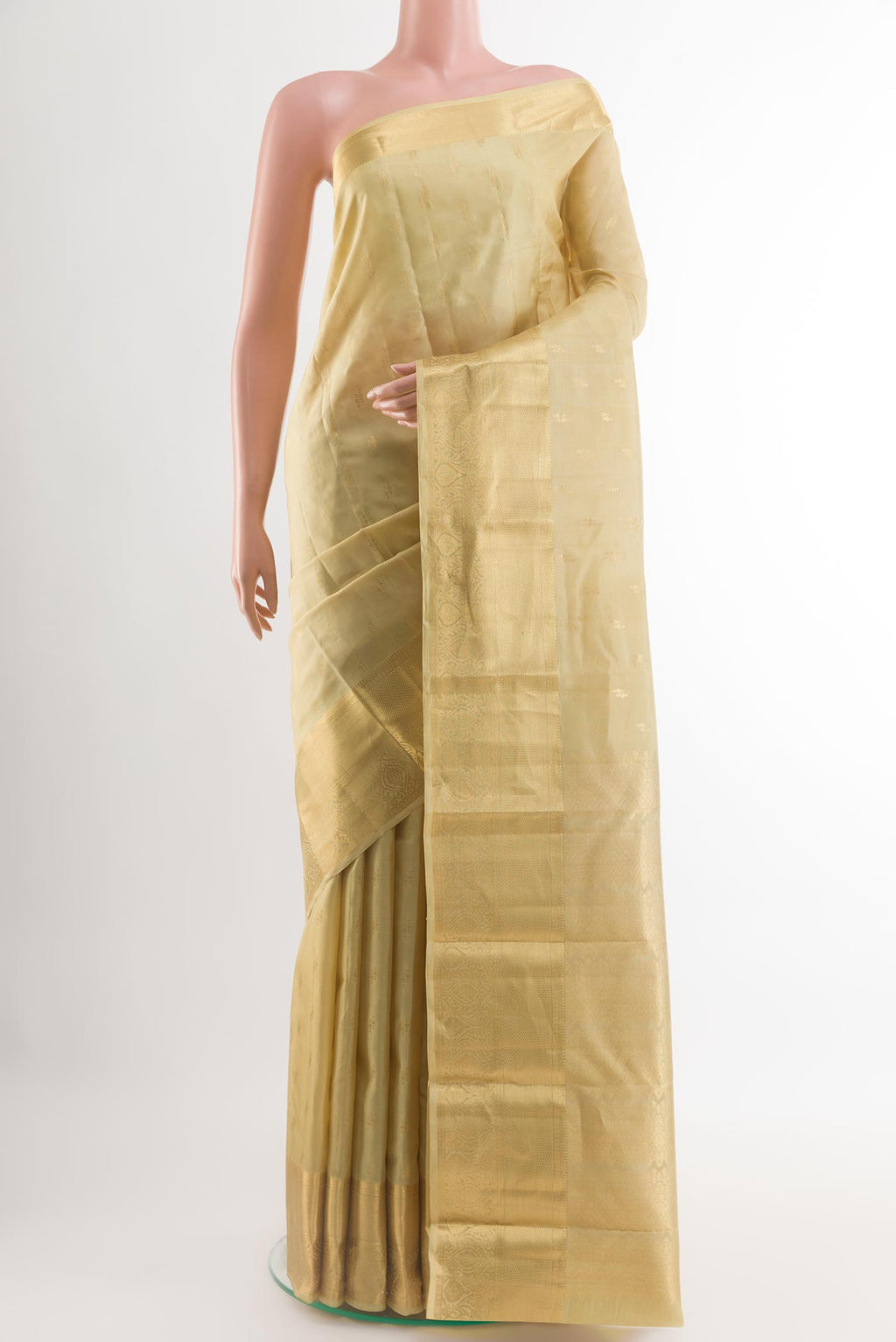 Off White Kanchipuram Silk Saree with Zari Butta on the body and Zari Border.  displayed on a mannequin
