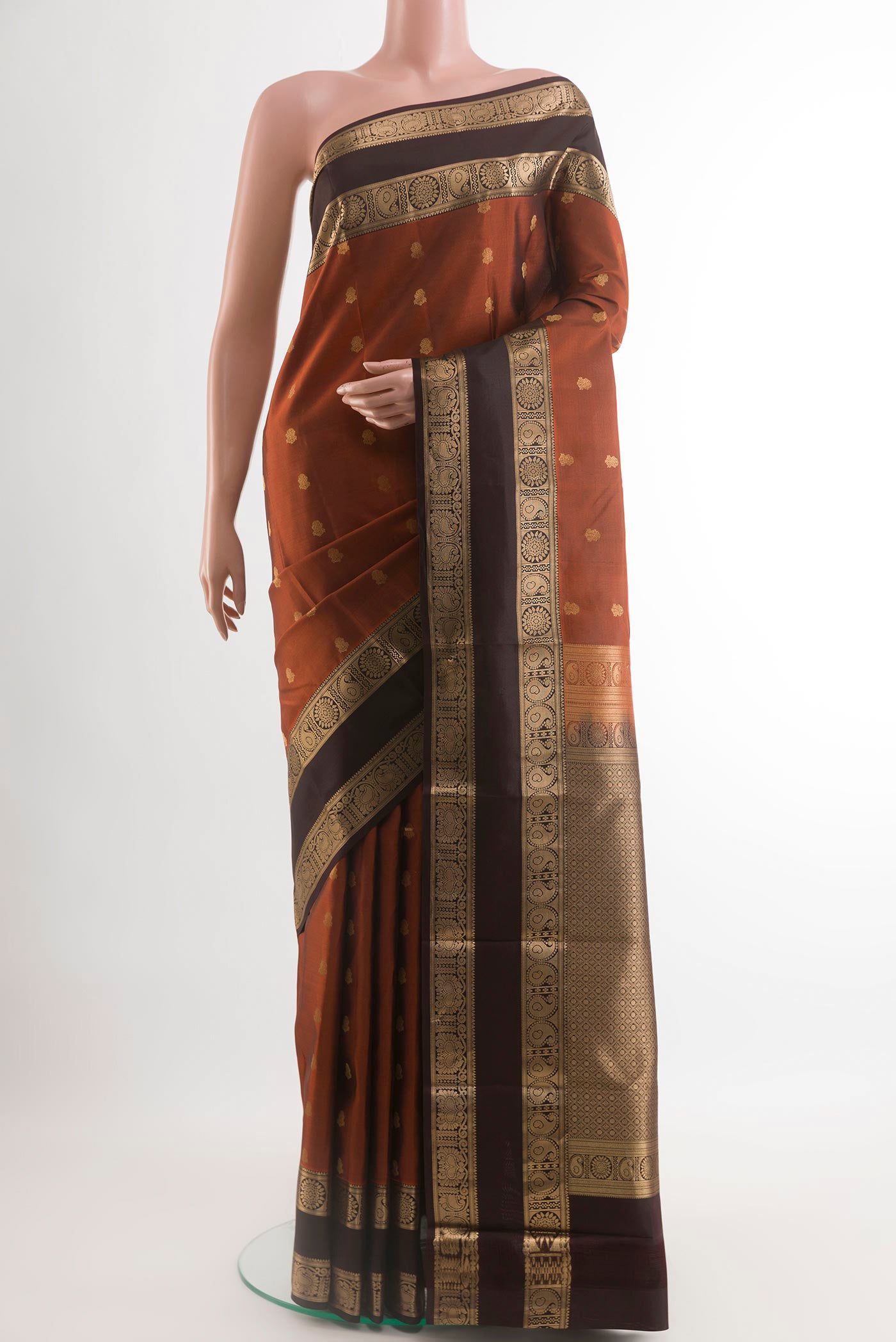 Brick Orange Kanchipuram Silk Saree with Zari Butta on the body and Zari Border.  displayed on a mannequin