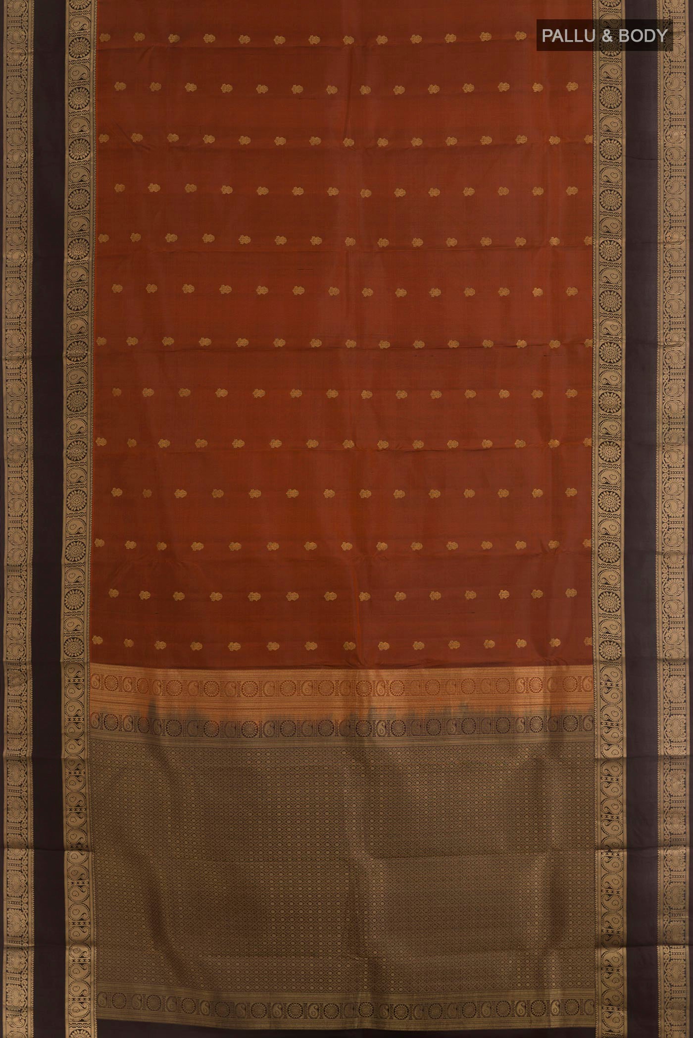 Flat view of Brick Orange Kanchipuram Silk Saree with Zari Butta on the body and Zari Border. 