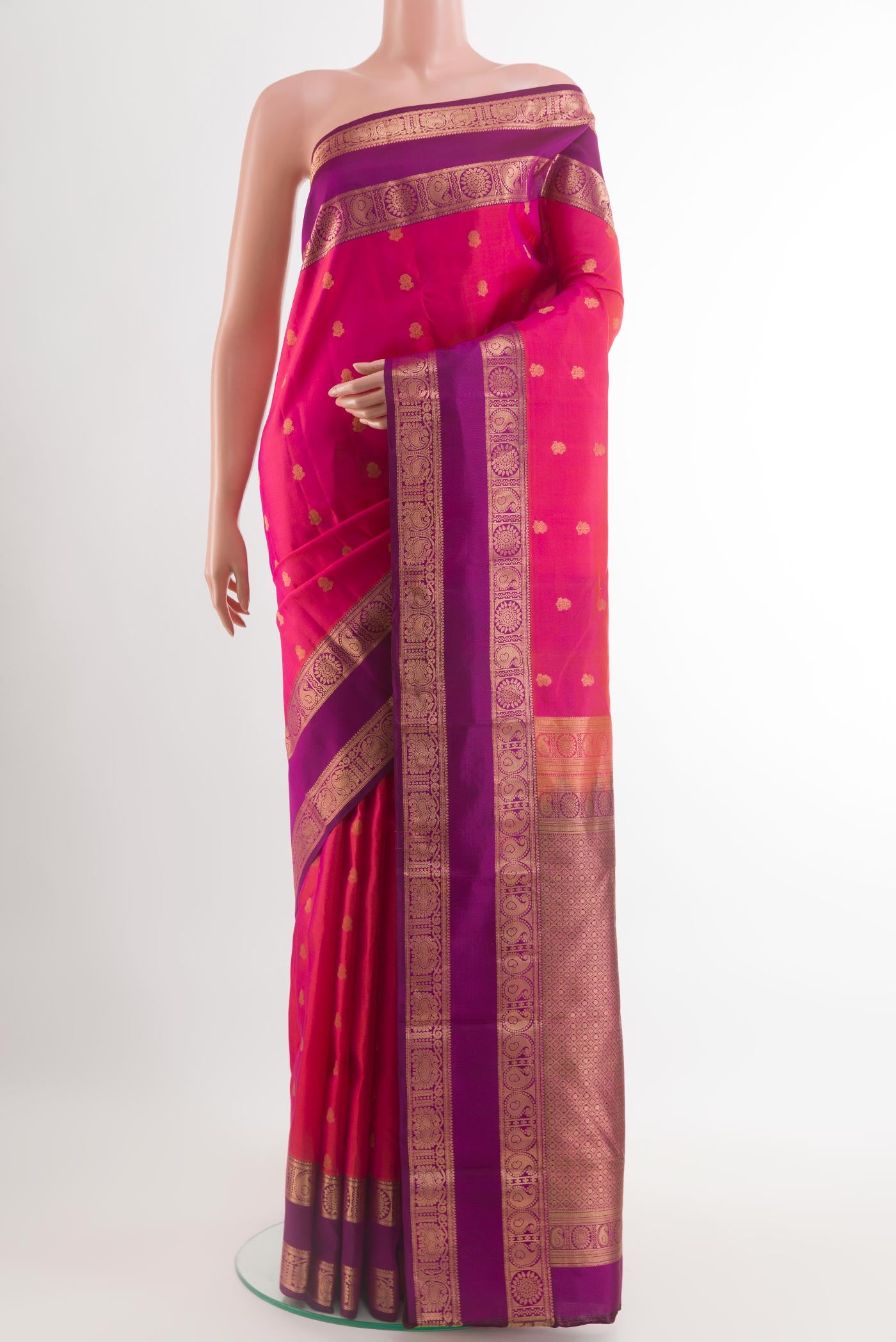 Pink Kanchipuram Silk Saree with Zari Butta on the body and Zari Border.  displayed on a mannequin